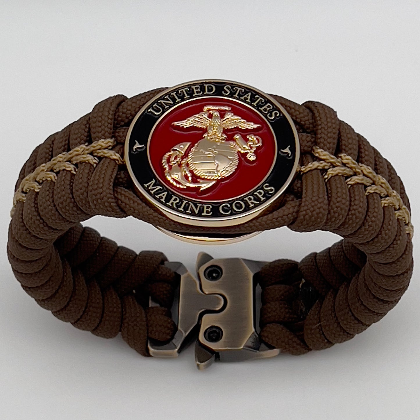 Thick, rigid and comfortable braided United States Marine Corps bracelet featuring a 24K gold plated USMC Eagle Globe and Anchor medallion, a gold Cobra style tactical buckle and woven with Coyote Brown 550 paracord and gold micro cord.