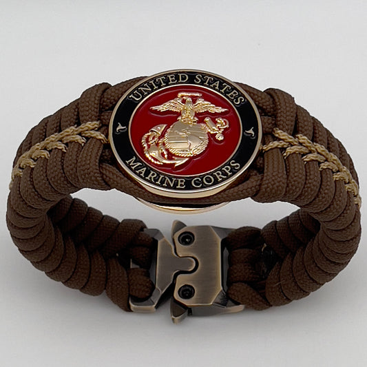 Thick, rigid and comfortable braided United States Marine Corps bracelet featuring a 24K gold plated USMC Eagle Globe and Anchor medallion, a gold Cobra style tactical buckle and woven with Coyote Brown 550 paracord and gold micro cord.