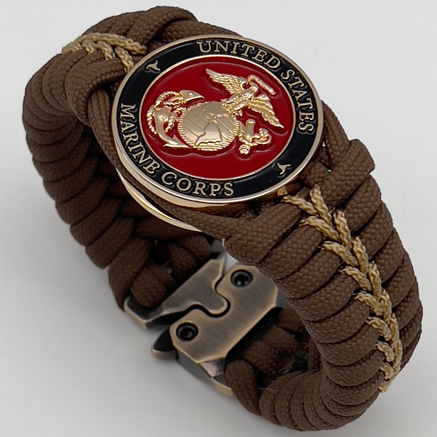 Thick, rigid and comfortable braided United States Marine Corps bracelet featuring a 24K gold plated USMC Eagle Globe and Anchor medallion, a gold Cobra style tactical buckle and woven with Coyote Brown 550 paracord and gold micro cord.