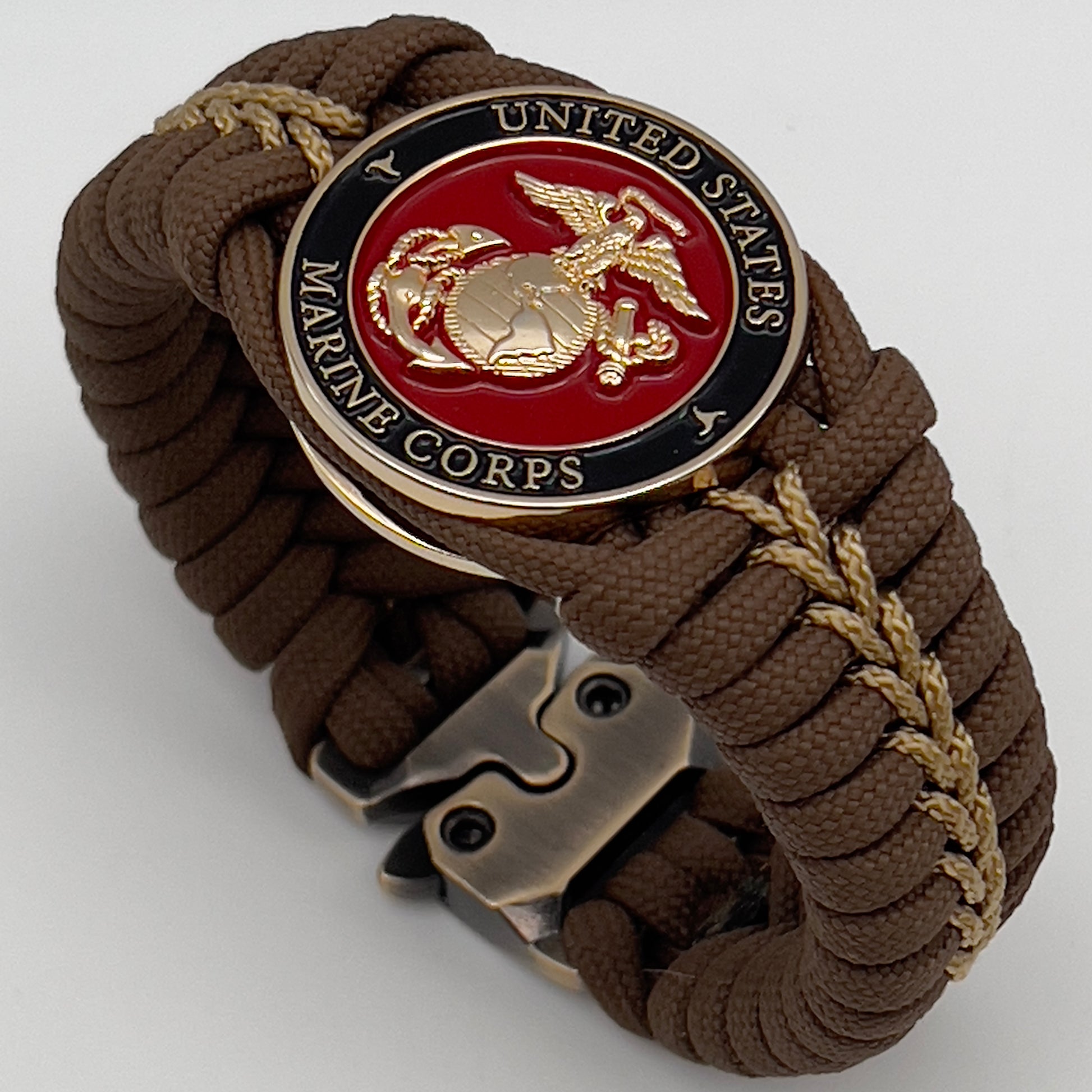 Thick, rigid and comfortable braided United States Marine Corps bracelet featuring a 24K gold plated USMC Eagle Globe and Anchor medallion, a gold Cobra style tactical buckle and woven with Coyote Brown 550 paracord and gold micro cord.