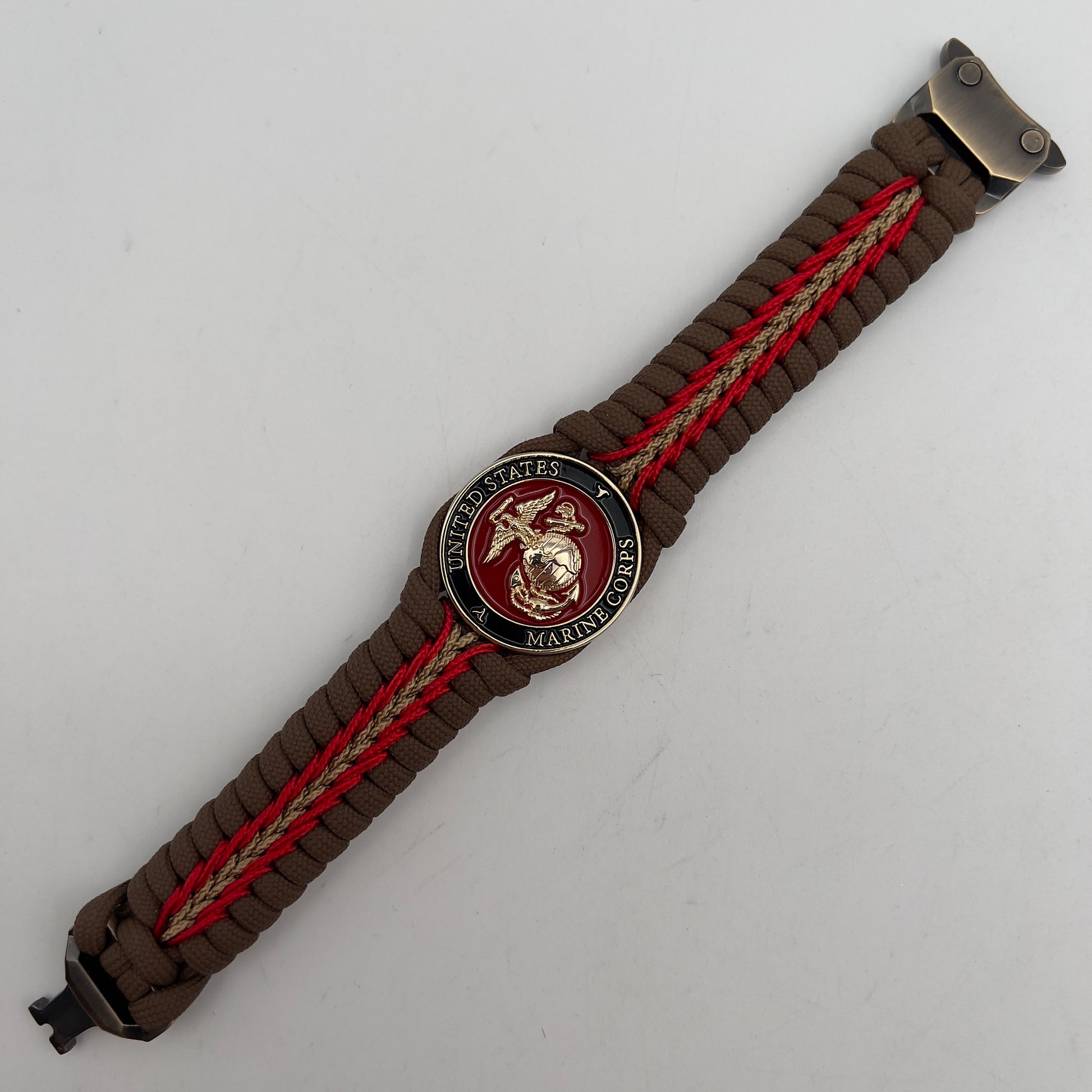 Thick, rigid and comfortable braided United States Marine Corps bracelet featuring a 24K gold plated USMC Eagle Globe and Anchor medallion, a gold Cobra style tactical buckle and woven with Coyote Brown 550 paracord and Imperial Red and gold micro cord.