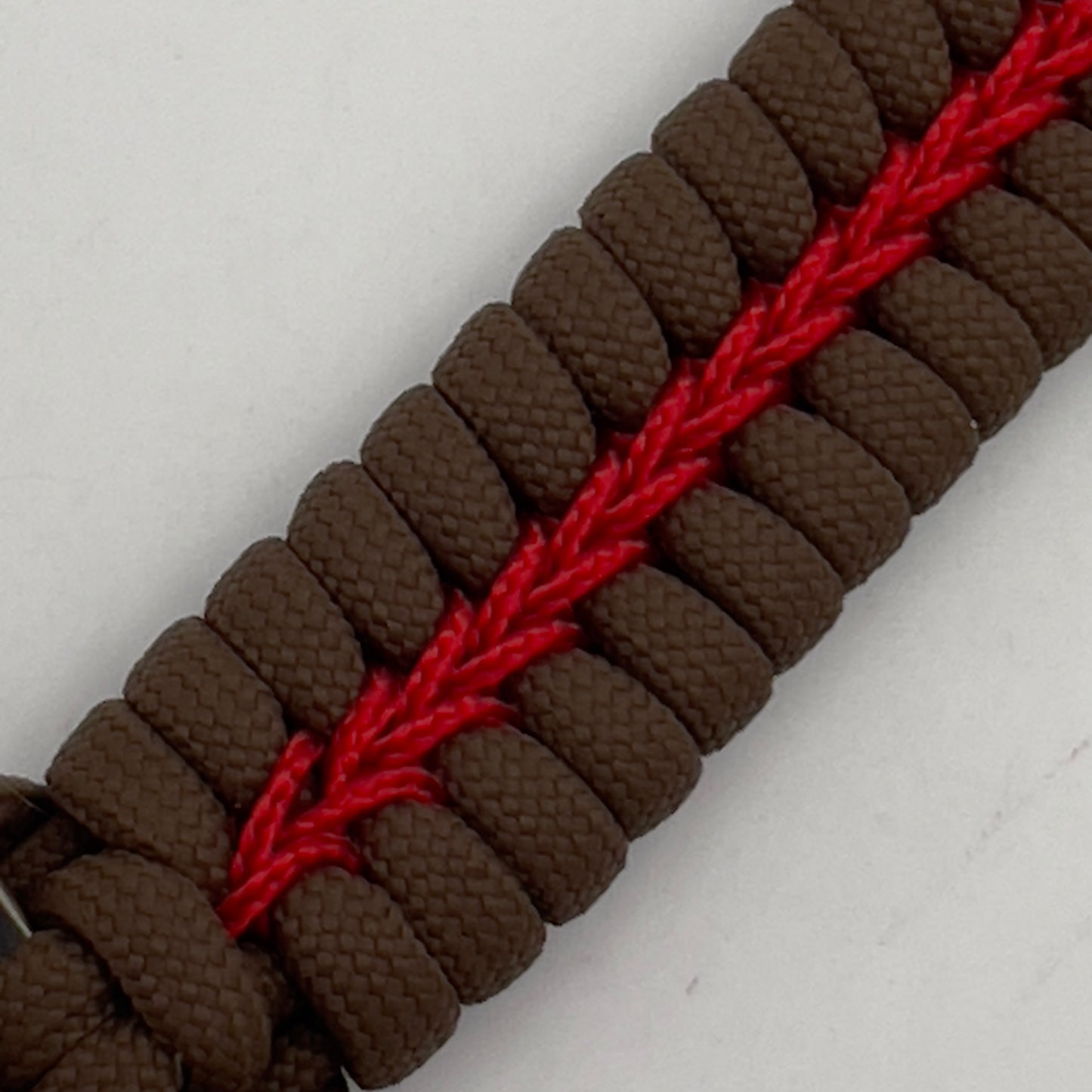 Thick, rigid and comfortable braided United States Marine Corps bracelet featuring a 24K gold plated USMC Eagle Globe and Anchor medallion, a gold Cobra style tactical buckle and woven with Coyote Brown 550 paracord and Imperial Red micro cord.