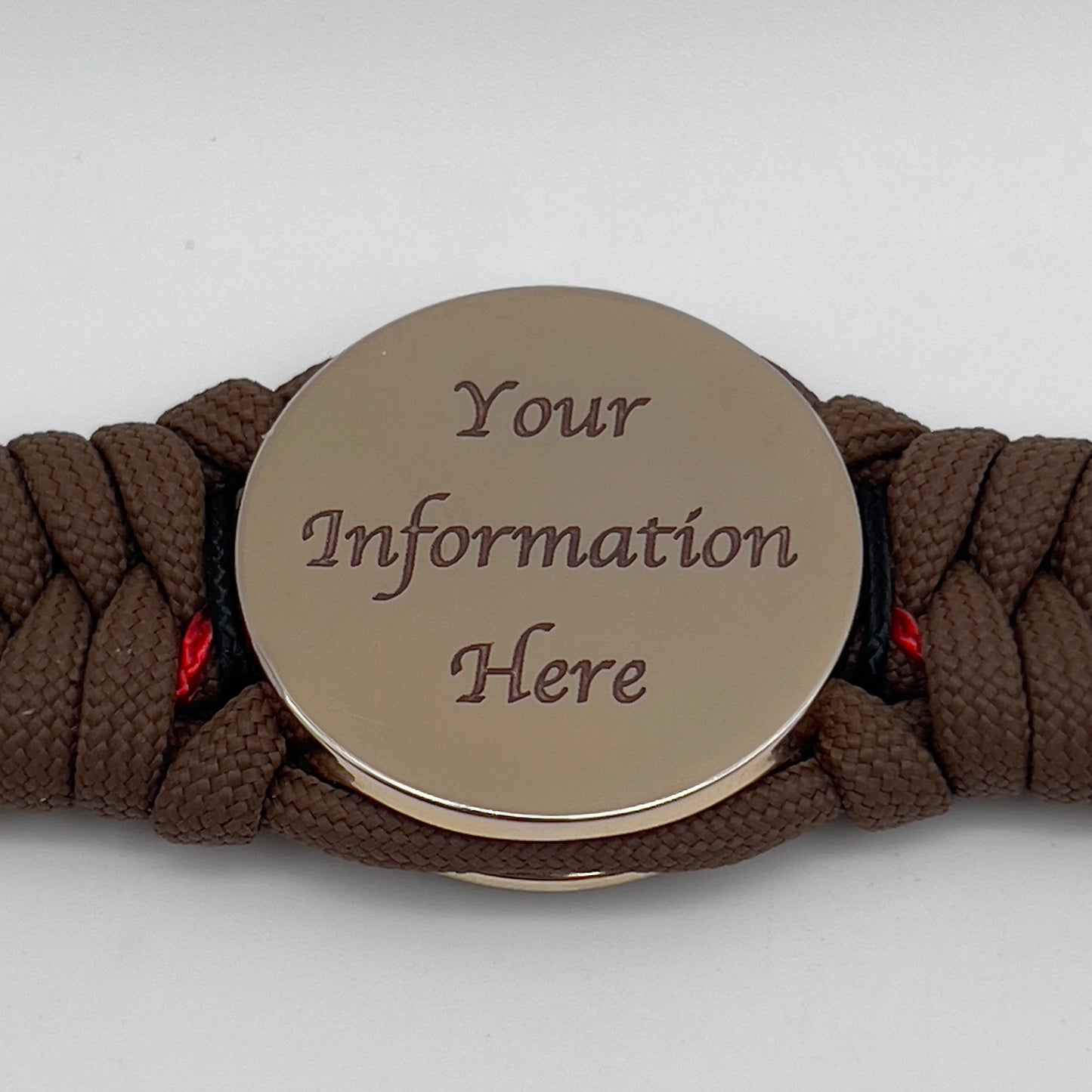 Thick, rigid and comfortable braided United States Marine Corps bracelet featuring a 24K gold plated USMC Eagle Globe and Anchor medallion, a gold Cobra style tactical buckle and woven with Coyote Brown 550 paracord and Imperial Red and black micro cord.