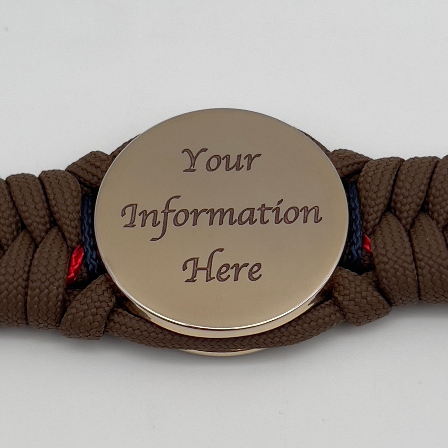 Thick, rigid and comfortable braided United States Marine Corps bracelet featuring a 24K gold plated USMC Eagle Globe and Anchor medallion, a gold Cobra style tactical buckle and woven with Coyote Brown 550 paracord and Imperial Red and Navy Blue micro cord.
