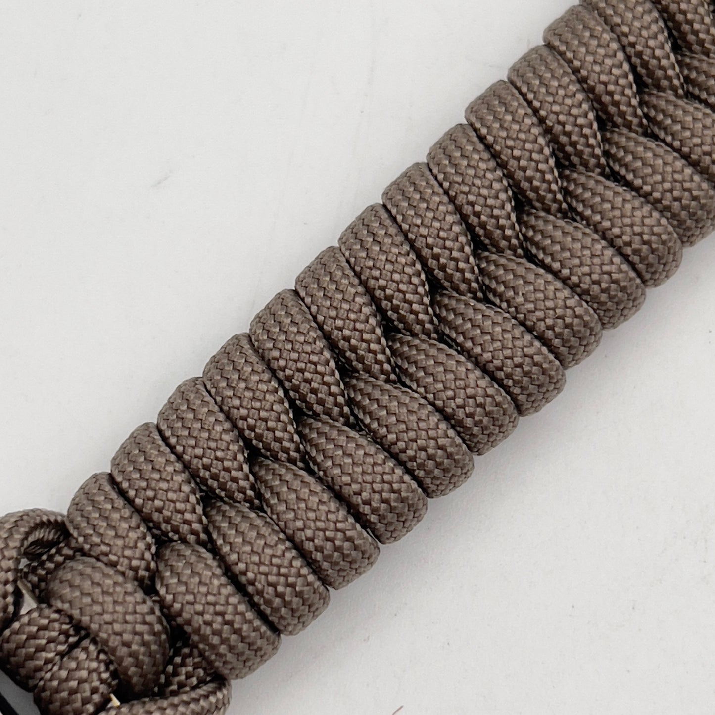 Thick, semi-rigid and comfortable braided United States Marine Corps bracelet featuring a 24K gold plated USMC Eagle Globe and Anchor medallion, a gold Cobra style tactical buckle and woven with tan 550 paracord.