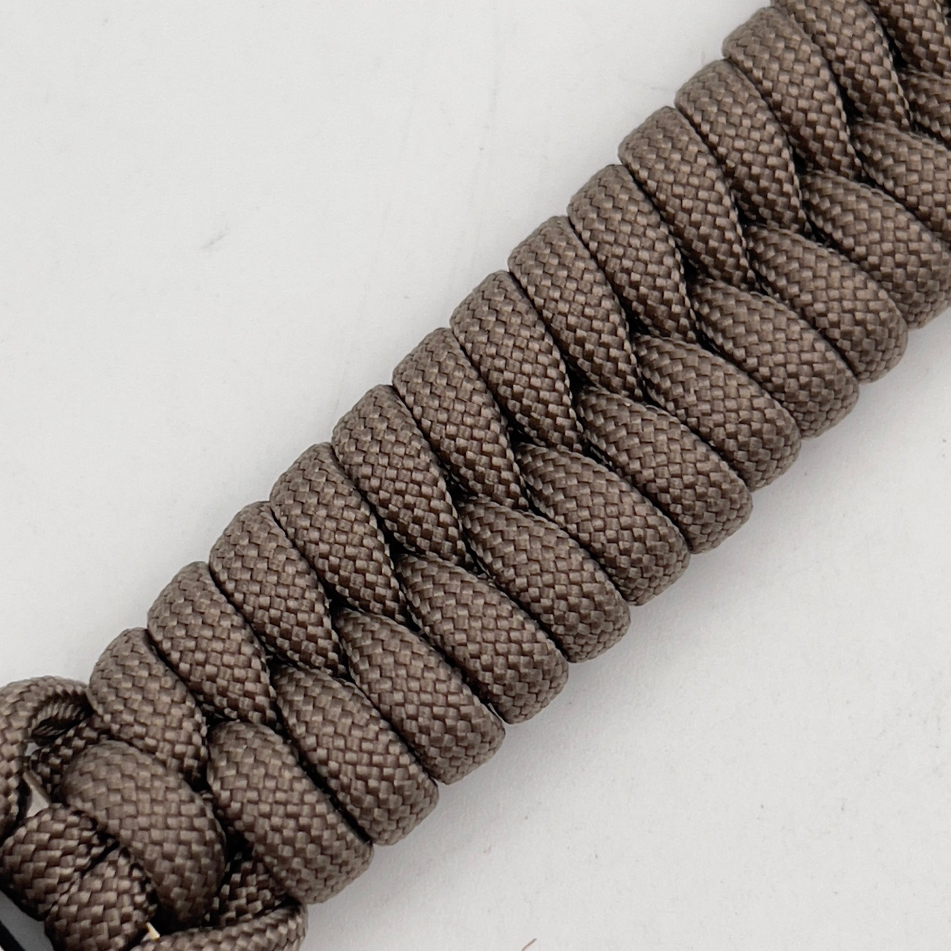 Thick, semi-rigid and comfortable braided United States Marine Corps bracelet featuring a 24K gold plated USMC Eagle Globe and Anchor medallion, a gold Cobra style tactical buckle and woven with tan 550 paracord.