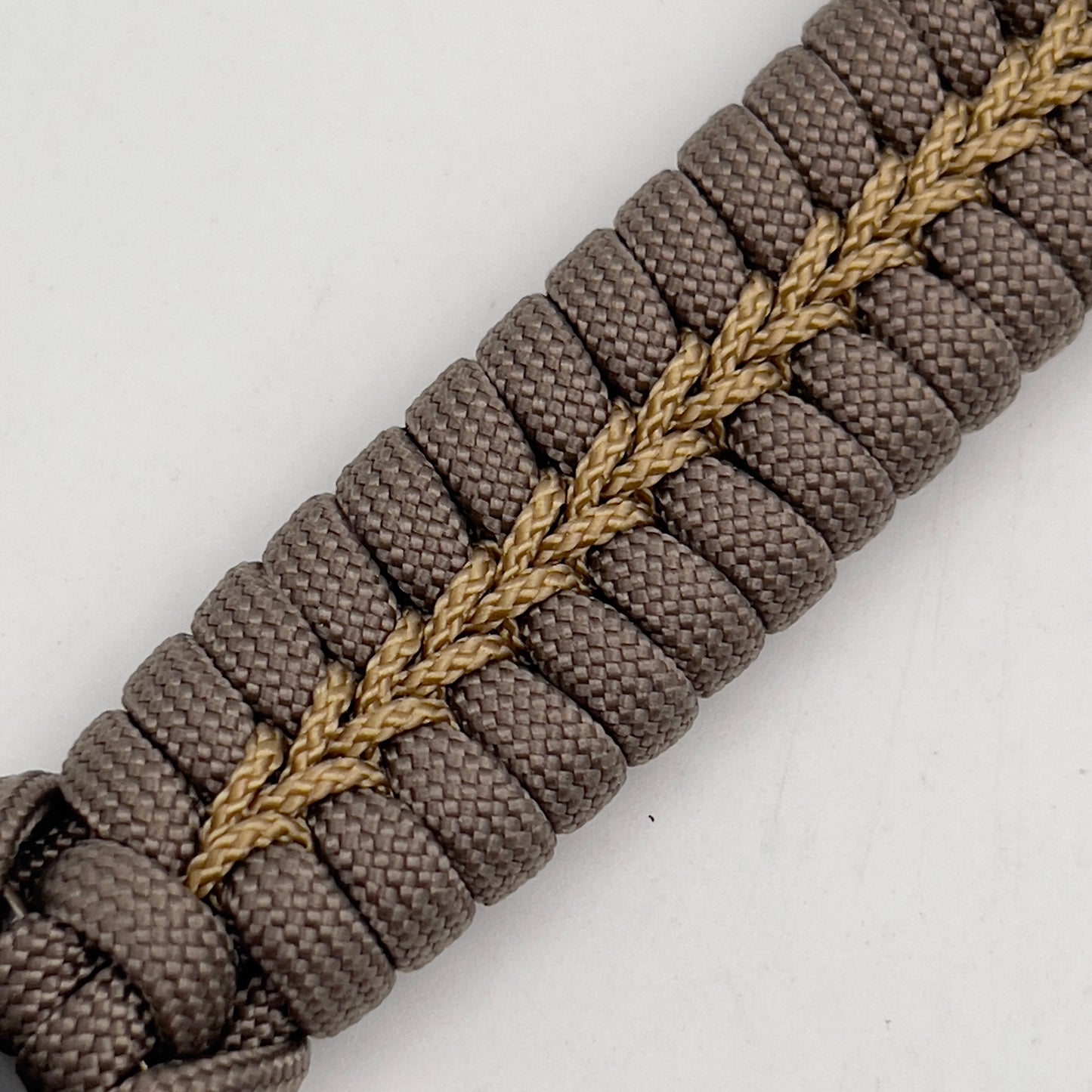Thick, semi-rigid and comfortable braided United States Marine Corps bracelet featuring a 24K gold plated USMC Eagle Globe and Anchor medallion, a gold Cobra style tactical buckle and woven with tan 550 paracord and gold micro cord.