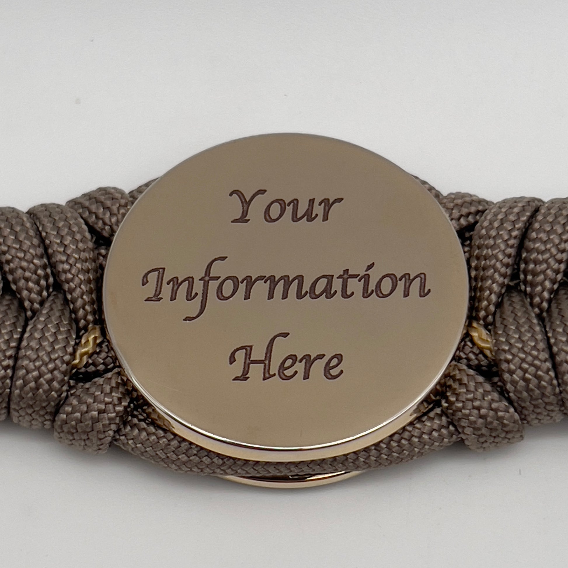 Thick, semi-rigid and comfortable braided United States Marine Corps bracelet featuring a 24K gold plated USMC Eagle Globe and Anchor medallion, a gold Cobra style tactical buckle and woven with tan 550 paracord and gold micro cord.