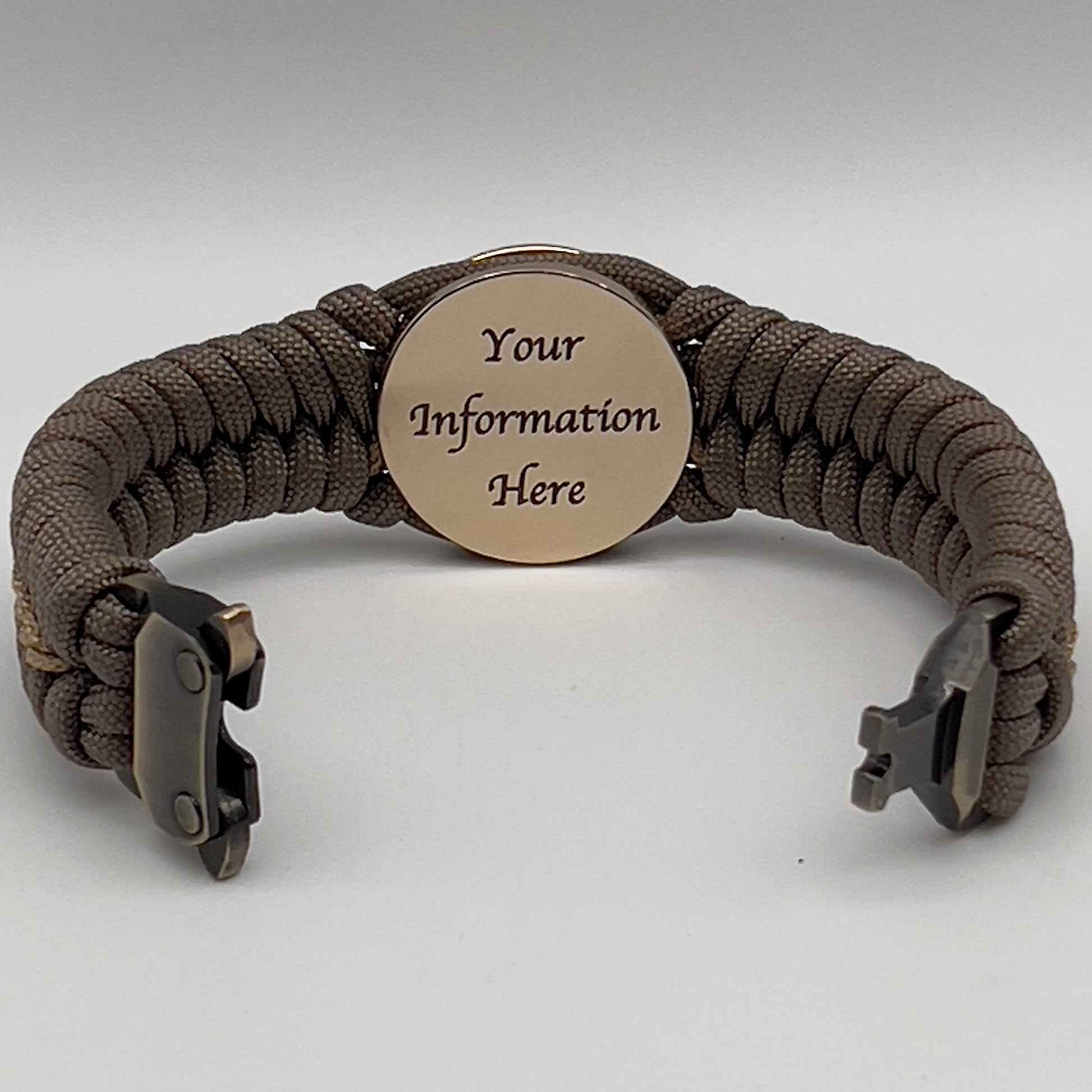 Thick, semi-rigid and comfortable braided United States Marine Corps bracelet featuring a 24K gold plated USMC Eagle Globe and Anchor medallion, a gold Cobra style tactical buckle and woven with tan 550 paracord and gold micro cord.