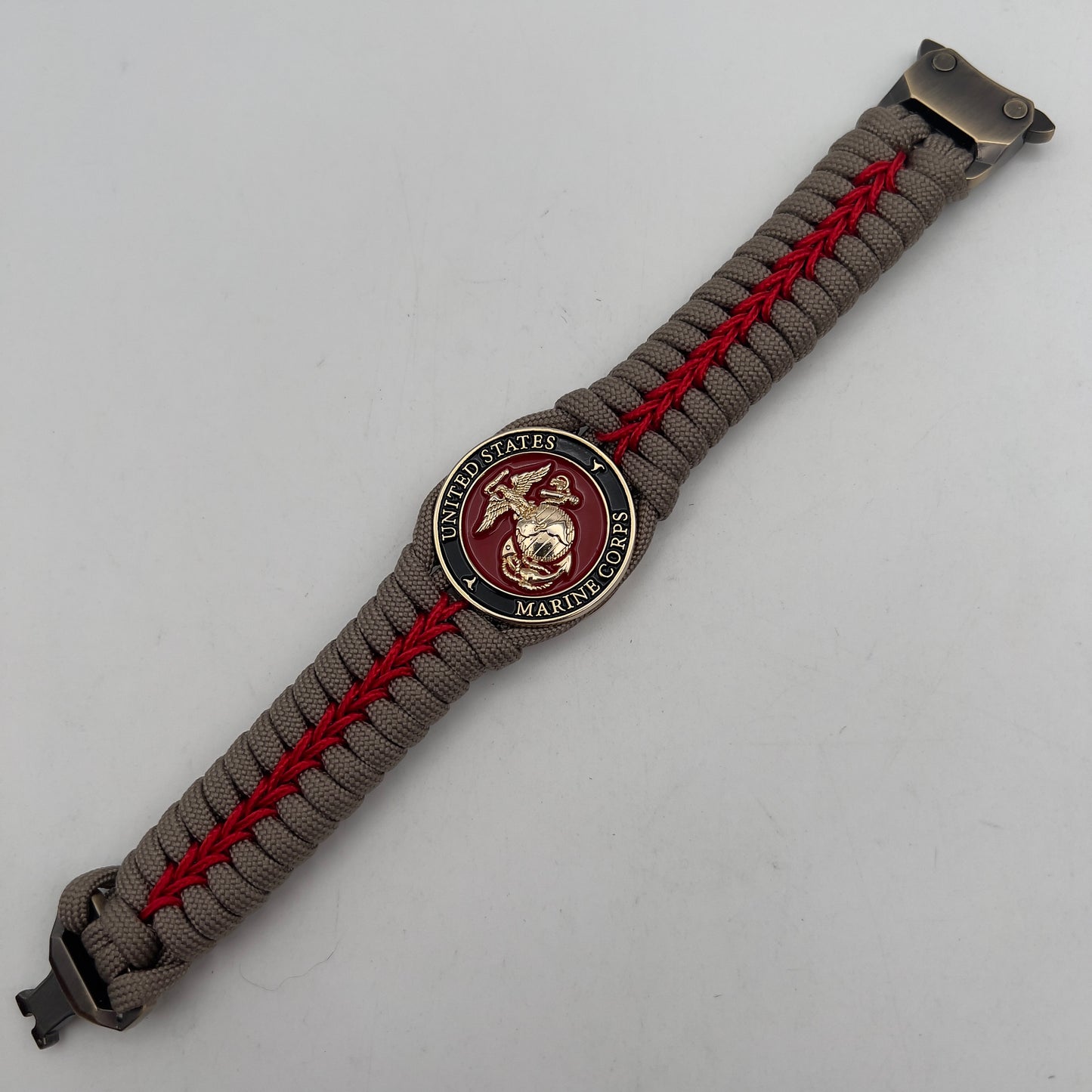 Thick, rigid and comfortable braided United States Marine Corps bracelet featuring a 24K gold plated USMC Eagle Globe and Anchor medallion, a gold Cobra style tactical buckle and woven with tan 550 paracord and Imperial Red micro cord.