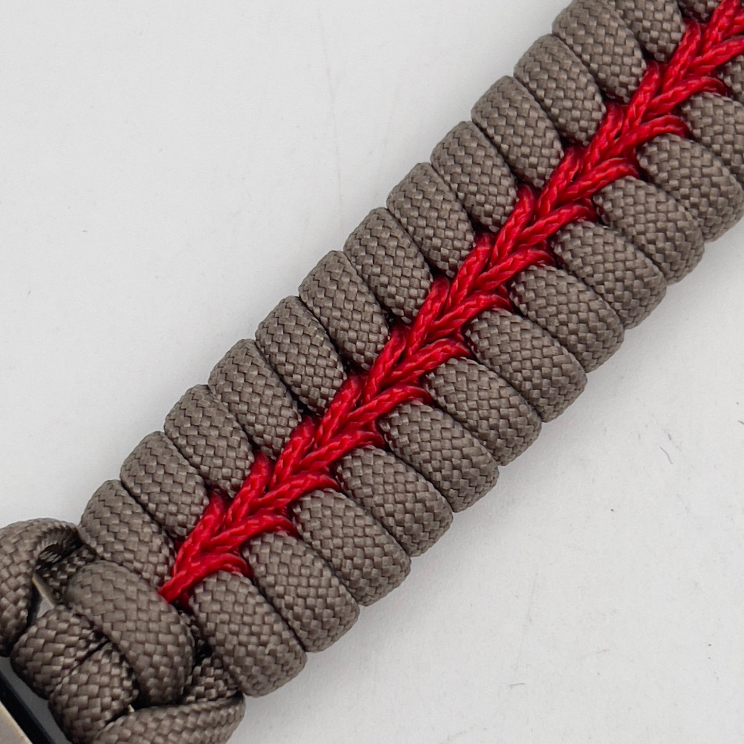 Thick, rigid and comfortable braided United States Marine Corps bracelet featuring a 24K gold plated USMC Eagle Globe and Anchor medallion, a gold Cobra style tactical buckle and woven with tan 550 paracord and Imperial Red micro cord.