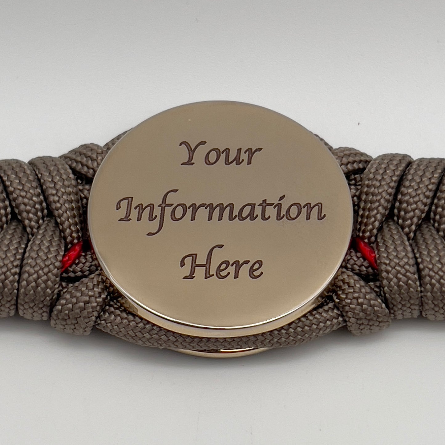 Thick, rigid and comfortable braided United States Marine Corps bracelet featuring a 24K gold plated USMC Eagle Globe and Anchor medallion, a gold Cobra style tactical buckle and woven with tan 550 paracord and Imperial Red micro cord.