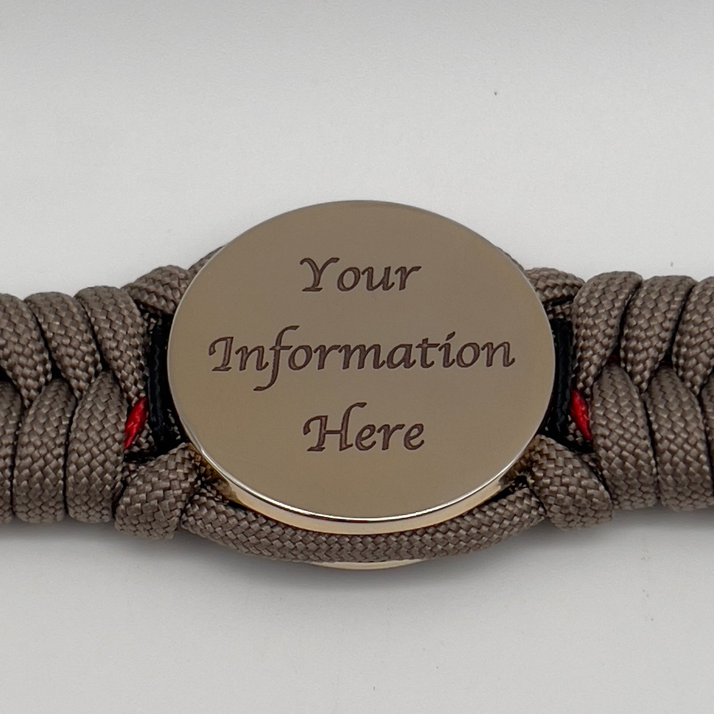 Thick, rigid and comfortable braided United States Marine Corps bracelet featuring a 24K gold plated USMC Eagle Globe and Anchor medallion, a gold Cobra style tactical buckle and woven with tan 550 paracord and Imperial Red and black micro cord.