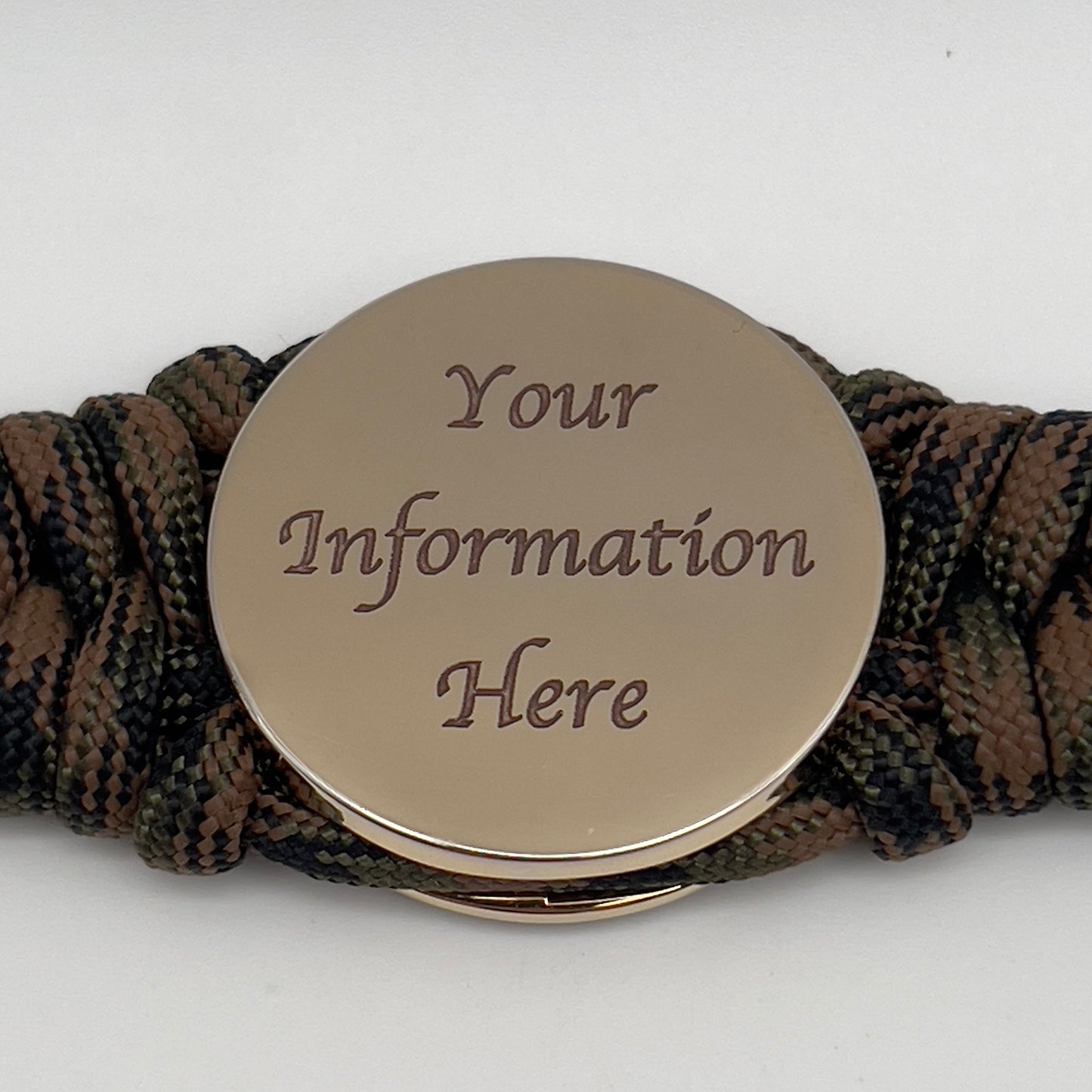 Thick, semi-rigid and comfortable braided United States Marine Corps bracelet featuring a 24K gold plated USMC Eagle Globe and Anchor medallion, a gold Cobra style tactical buckle and woven with Woodland camo 550 paracord.