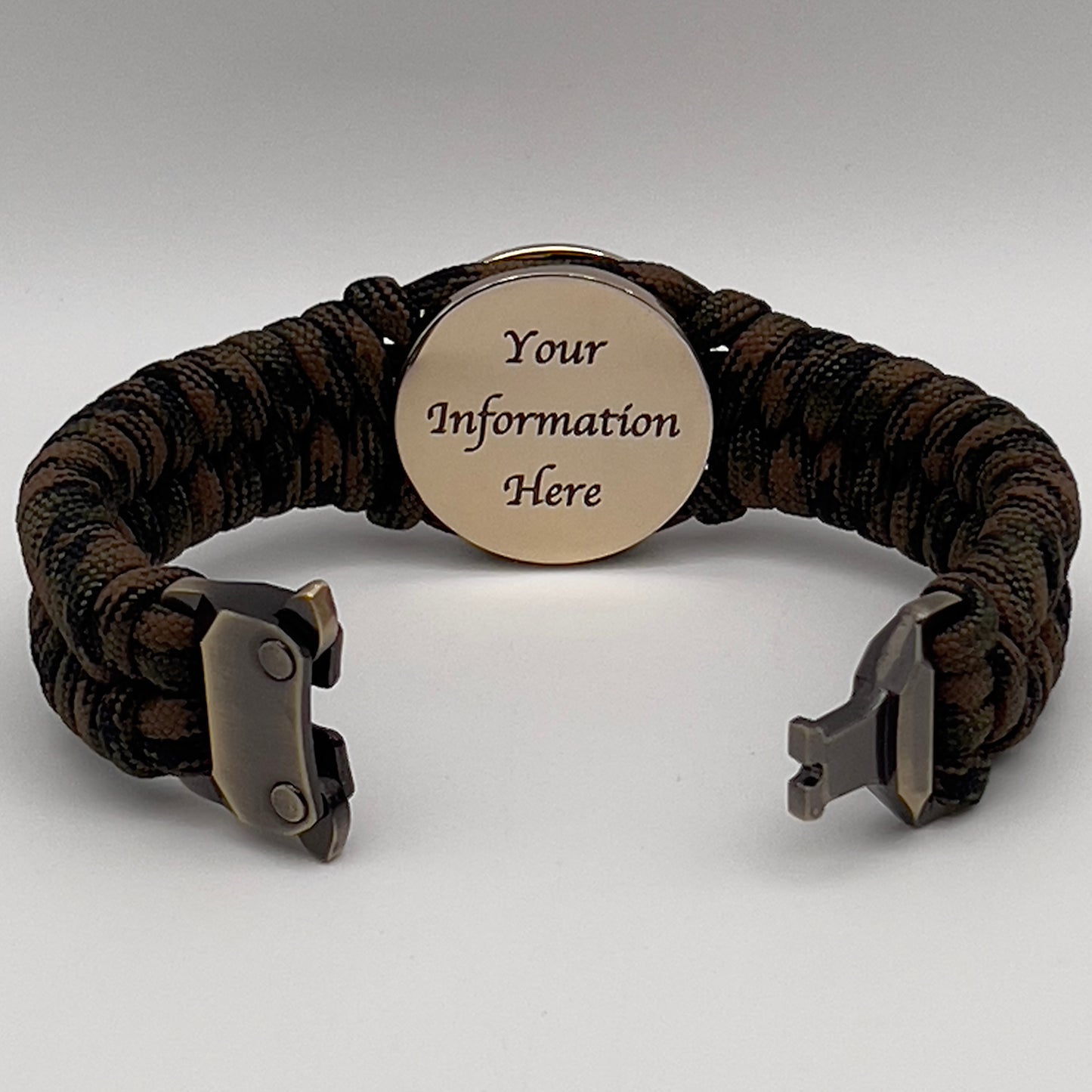 Thick, semi-rigid and comfortable braided United States Marine Corps bracelet featuring a 24K gold plated USMC Eagle Globe and Anchor medallion, a gold Cobra style tactical buckle and woven with Woodland camo 550 paracord.