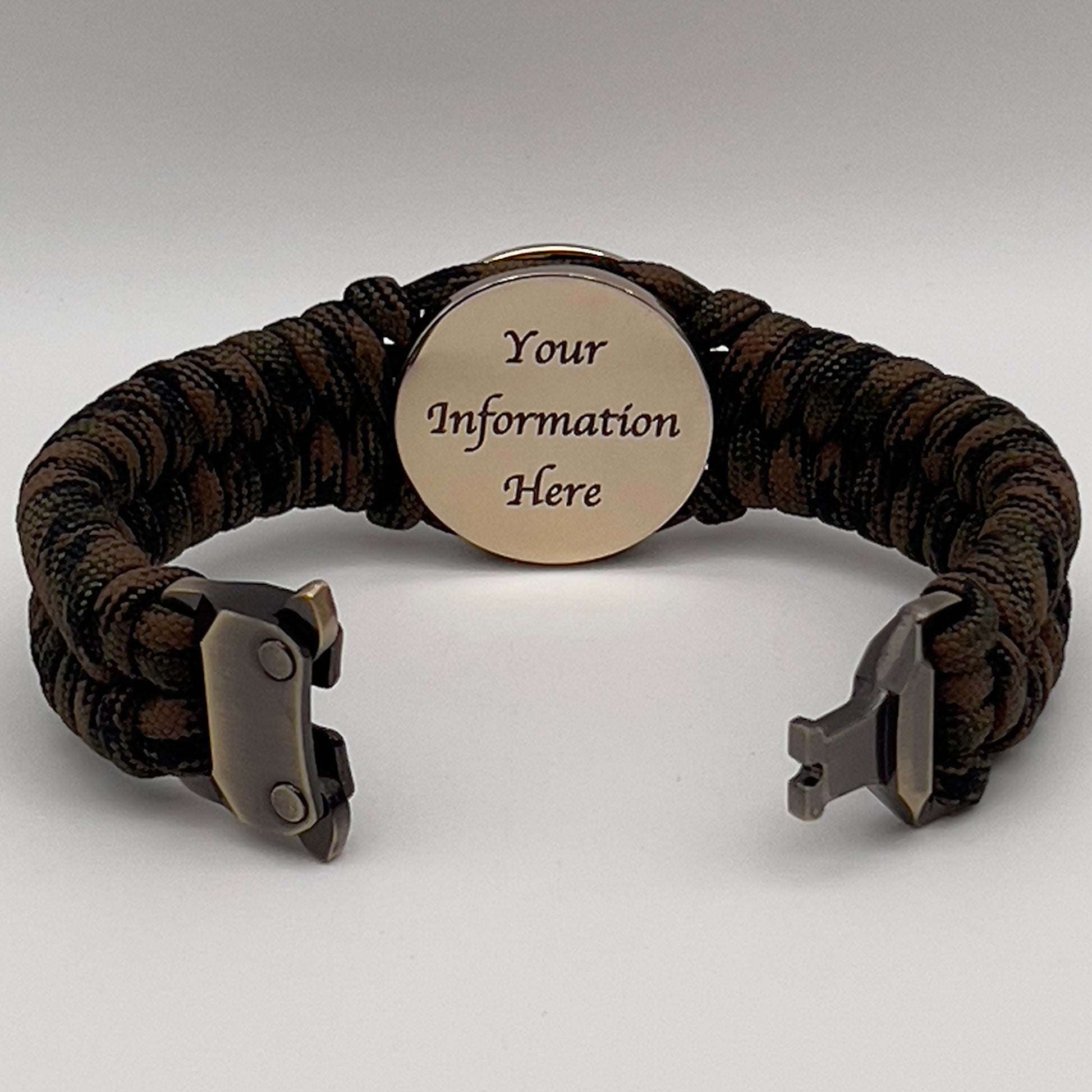 Thick, semi-rigid and comfortable braided United States Marine Corps bracelet featuring a 24K gold plated USMC Eagle Globe and Anchor medallion, a gold Cobra style tactical buckle and woven with Woodland camo 550 paracord.