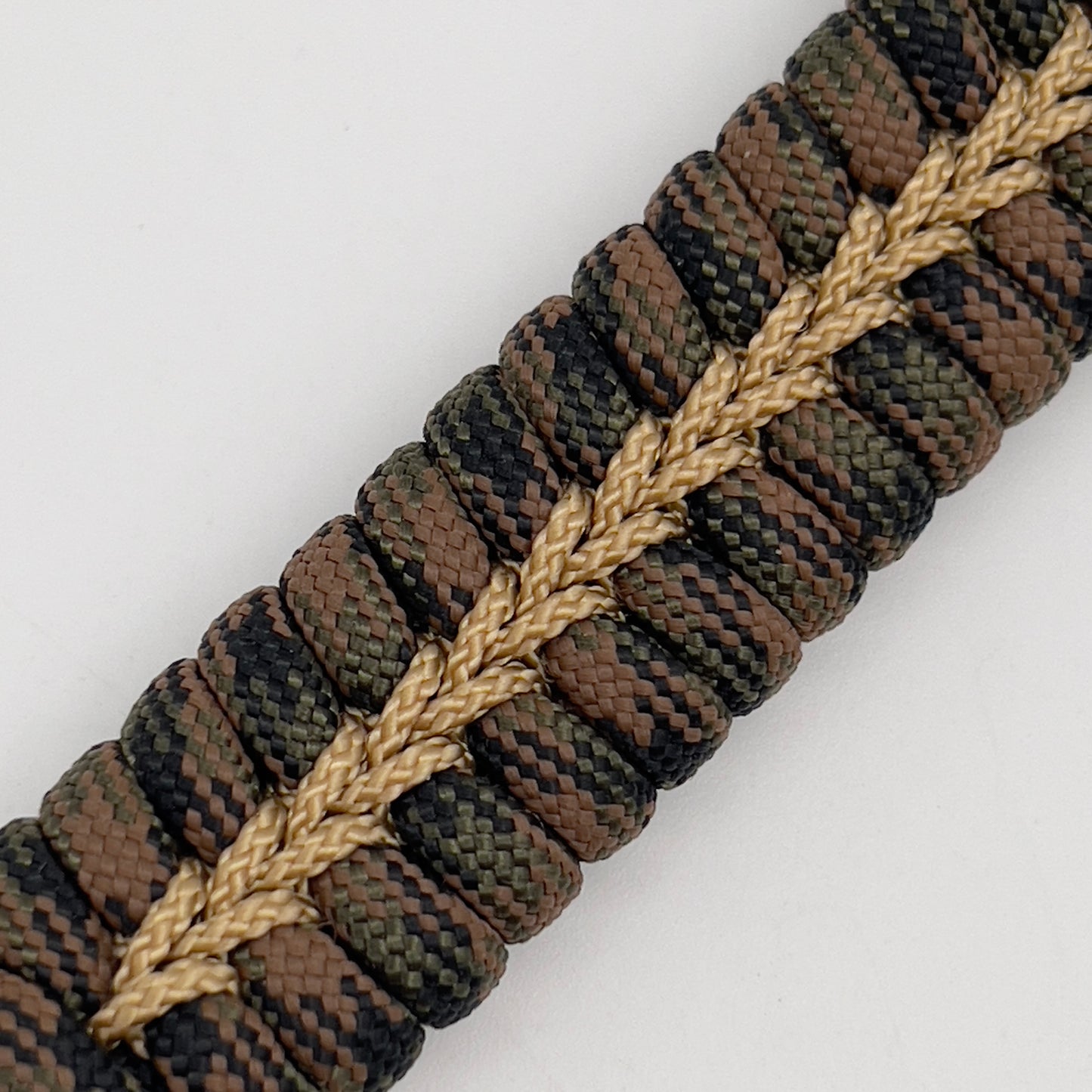 Thick, rigid and comfortable braided United States Marine Corps bracelet featuring a 24K gold plated USMC Eagle Globe and Anchor medallion, a gold Cobra style tactical buckle and woven with Woodland 550 paracord.