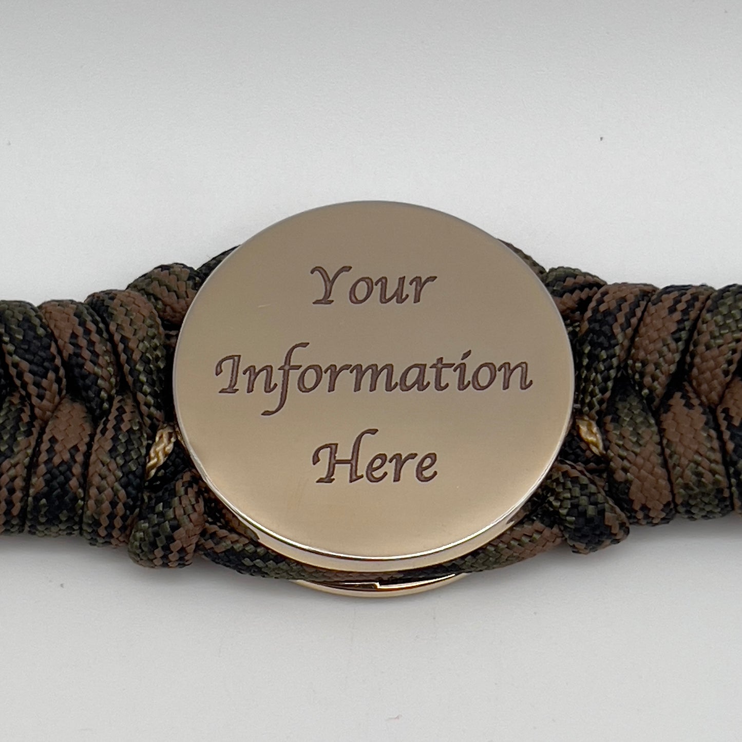 Thick, rigid and comfortable braided United States Marine Corps bracelet featuring a 24K gold plated USMC Eagle Globe and Anchor medallion, a gold Cobra style tactical buckle and woven with Woodland 550 paracord.