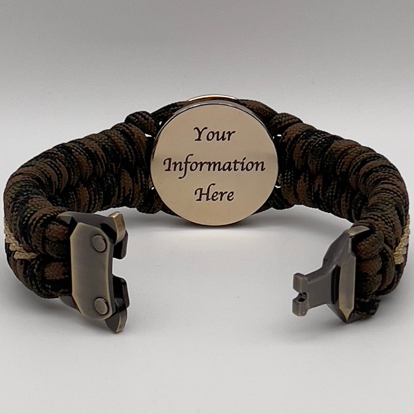 Thick, rigid and comfortable braided United States Marine Corps bracelet featuring a 24K gold plated USMC Eagle Globe and Anchor medallion, a gold Cobra style tactical buckle and woven with Woodland 550 paracord.