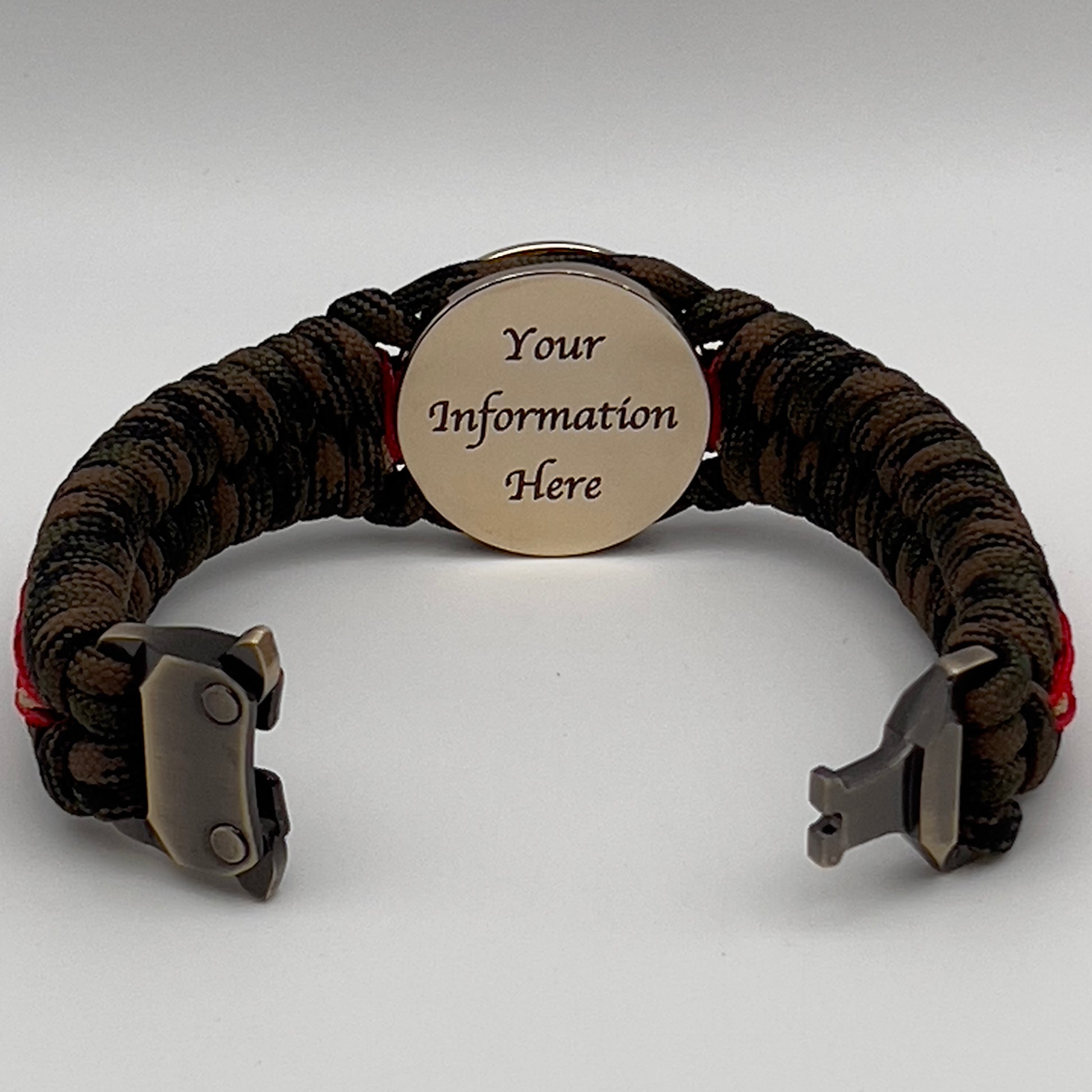 Thick, rigid and comfortable braided United States Marine Corps bracelet featuring a 24K gold plated USMC Eagle Globe and Anchor medallion, a gold Cobra style tactical buckle and woven with Woodland camo 550 paracord and Imperial Red and Gold micro cord.