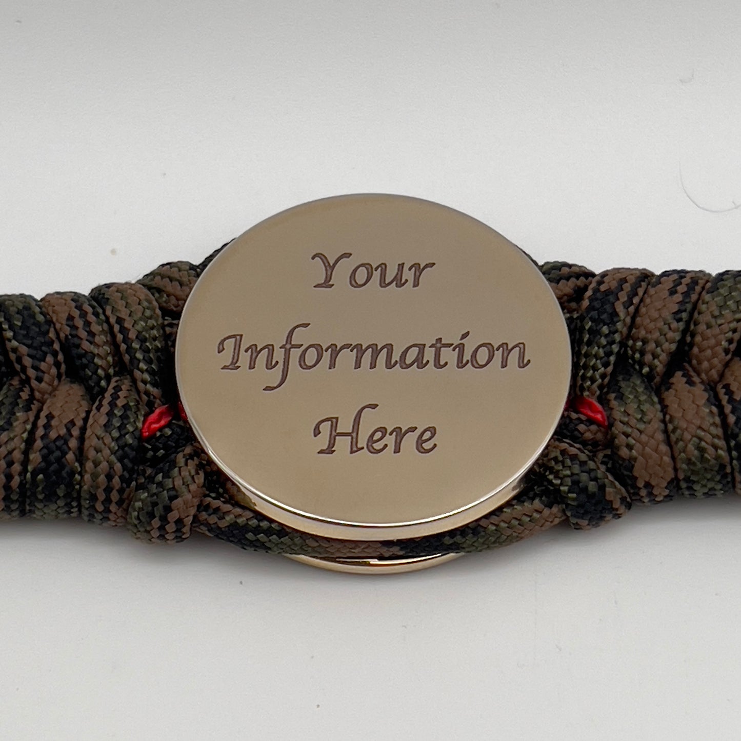 Thick, rigid and comfortable braided United States Marine Corps bracelet featuring a 24K gold plated USMC Eagle Globe and Anchor medallion, a gold Cobra style tactical buckle and woven with Woodland Camo 550 paracord and Imperial Red micro cord.
