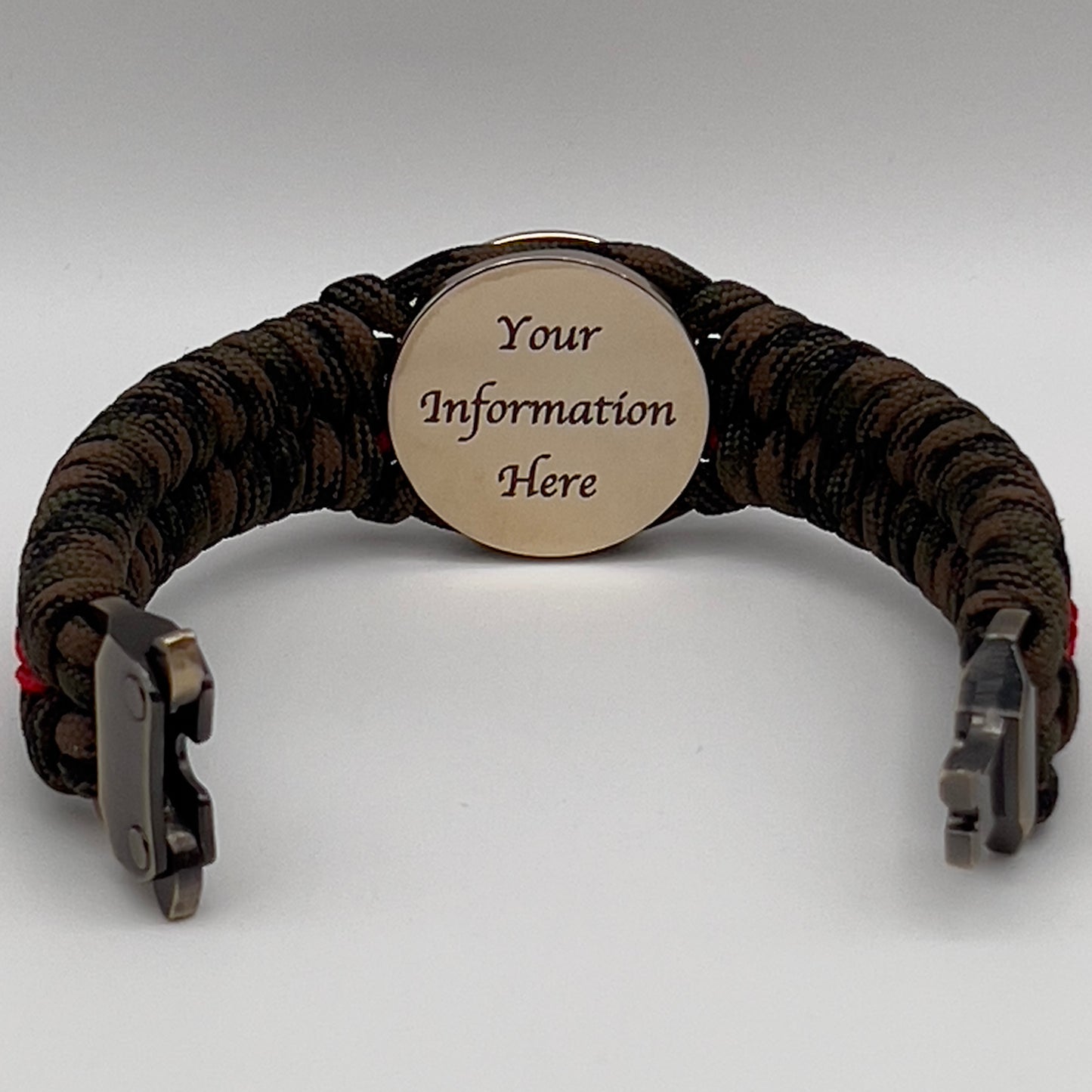 Thick, rigid and comfortable braided United States Marine Corps bracelet featuring a 24K gold plated USMC Eagle Globe and Anchor medallion, a gold Cobra style tactical buckle and woven with Woodland Camo 550 paracord and Imperial Red micro cord.