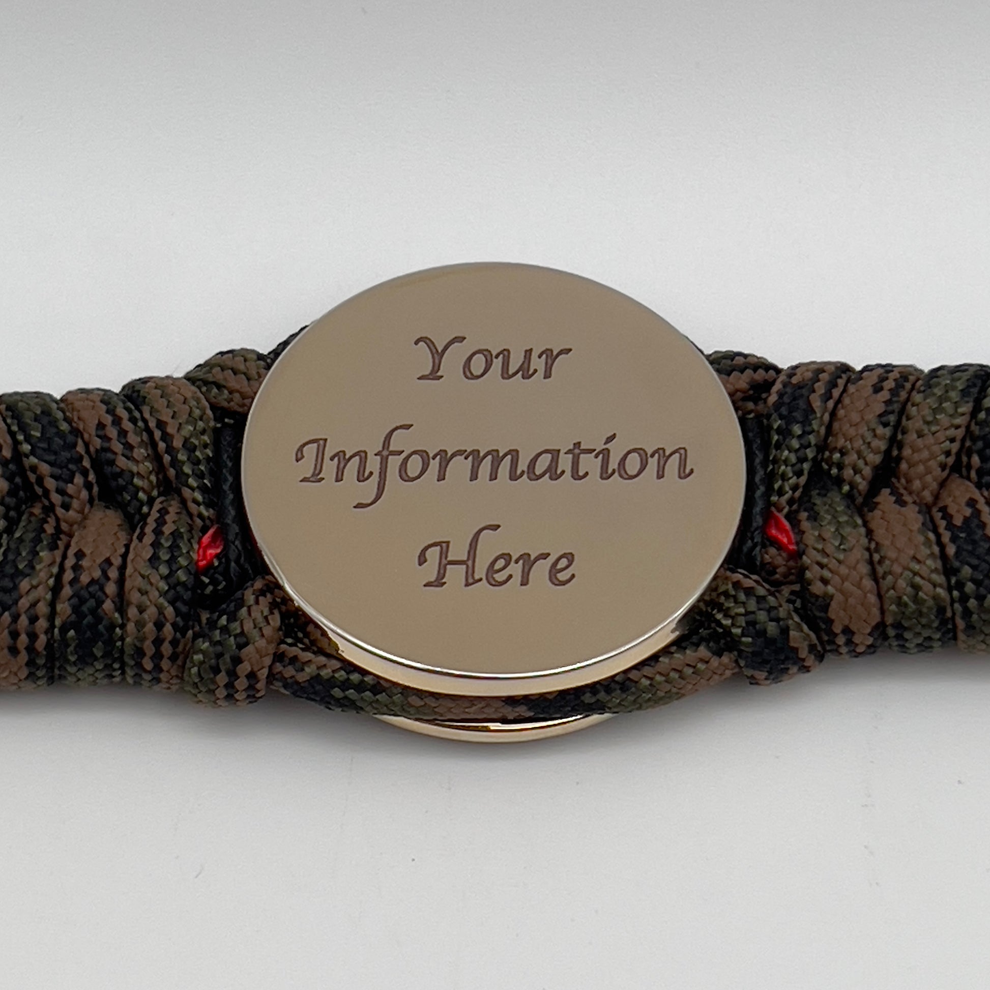 Thick, semi-rigid and comfortable braided United States Marine Corps bracelet featuring a 24K gold plated USMC Eagle Globe and Anchor medallion, a gold Cobra style tactical buckle and woven with Woodland camo 550 paracord and black and Imperial red micro cord.