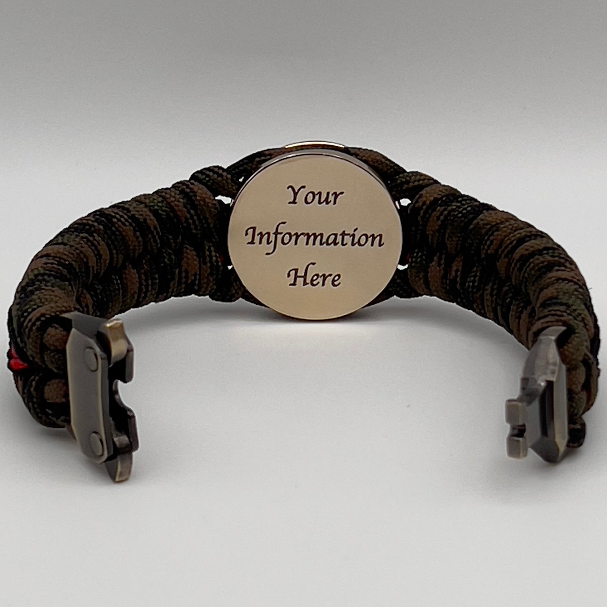 Thick, semi-rigid and comfortable braided United States Marine Corps bracelet featuring a 24K gold plated USMC Eagle Globe and Anchor medallion, a gold Cobra style tactical buckle and woven with Woodland camo 550 paracord and black and Imperial red micro cord.