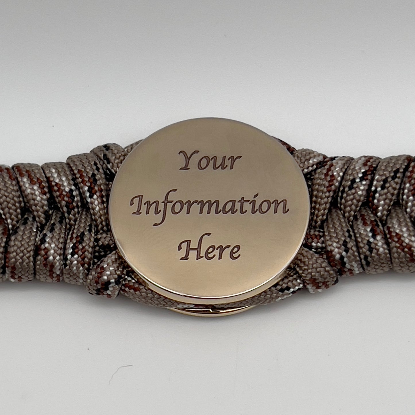 Thick, semi-rigid and comfortable braided United States Marine Corps bracelet featuring a 24K gold plated USMC Eagle Globe and Anchor medallion, a gold Cobra style tactical buckle and woven with Desert Camo 550 paracord.