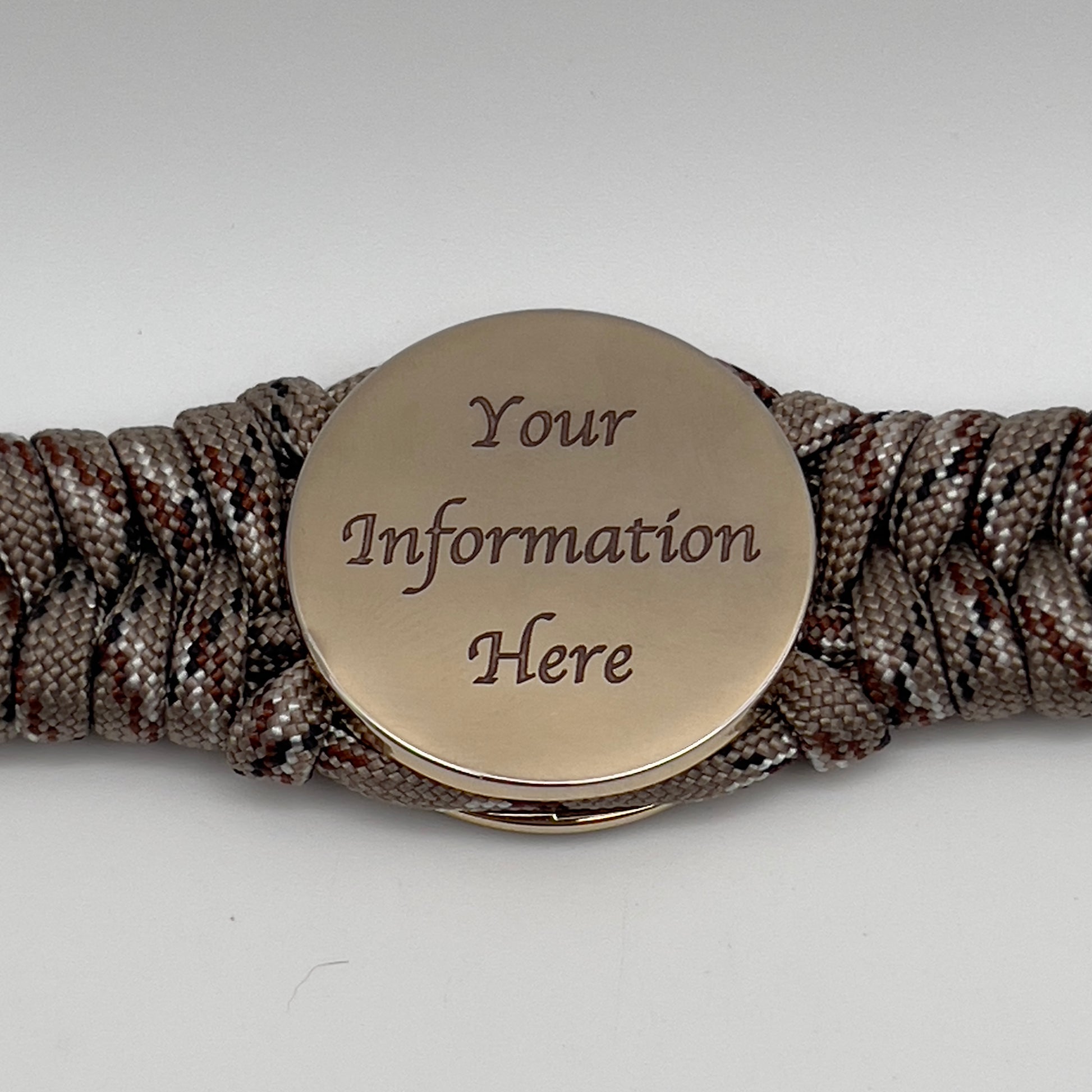 Thick, semi-rigid and comfortable braided United States Marine Corps bracelet featuring a 24K gold plated USMC Eagle Globe and Anchor medallion, a gold Cobra style tactical buckle and woven with Desert Camo 550 paracord.