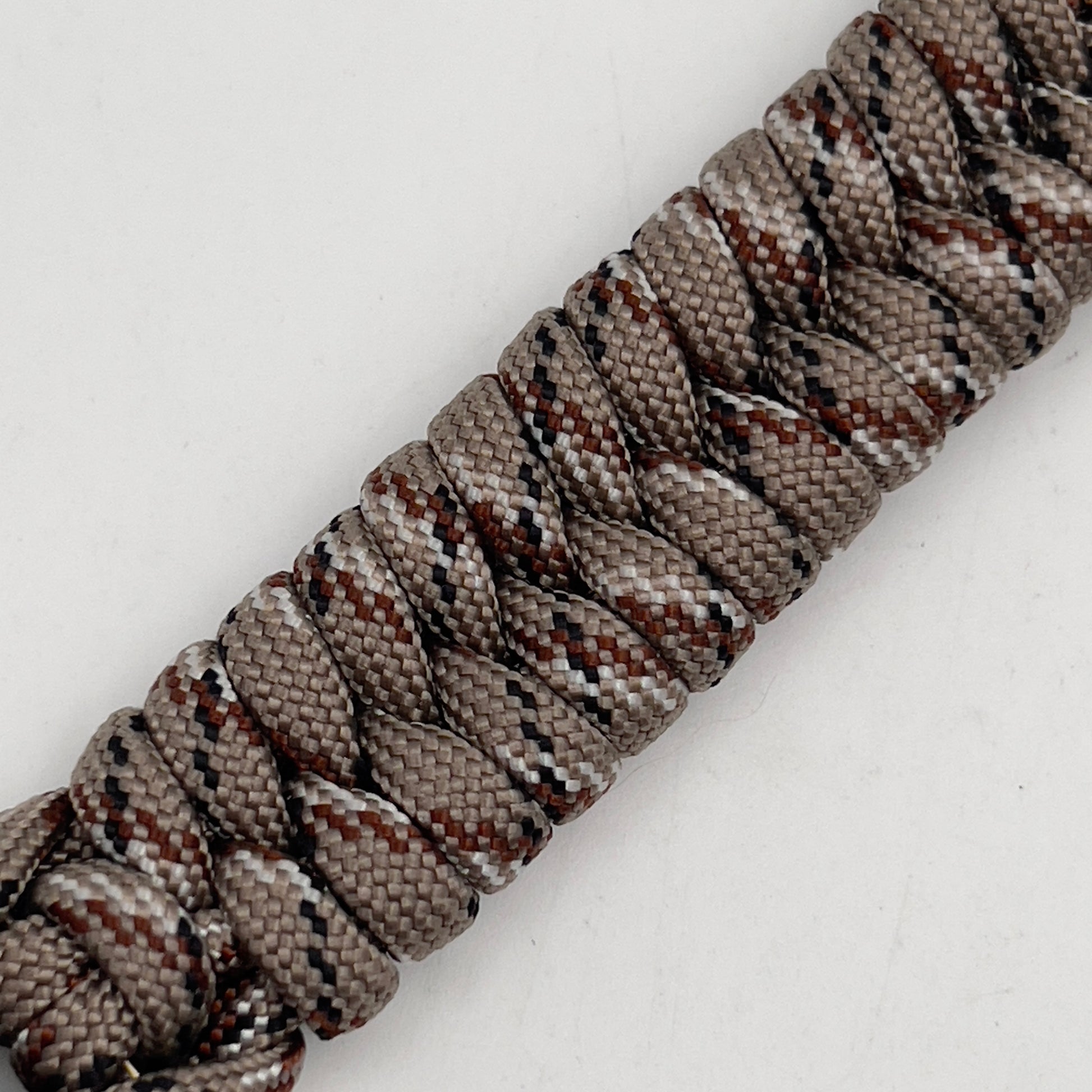 Thick, semi-rigid and comfortable braided United States Marine Corps bracelet featuring a 24K gold plated USMC Eagle Globe and Anchor medallion, a gold Cobra style tactical buckle and woven with Desert Camo 550 paracord.