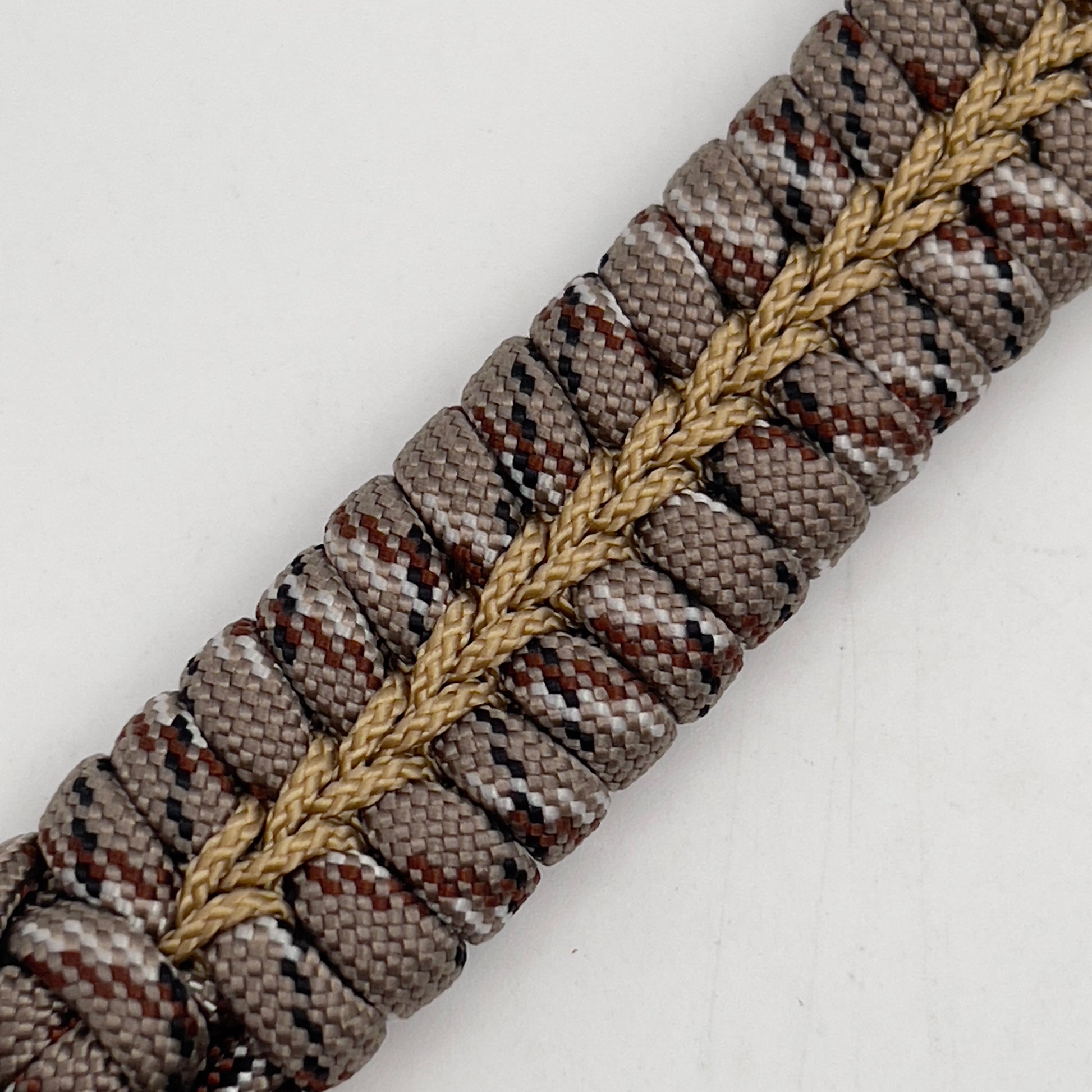 Thick, rigid and comfortable braided United States Marine Corps bracelet featuring a 24K gold plated USMC Eagle Globe and Anchor medallion, a gold Cobra style tactical buckle and woven with Desert Camo 550 paracord.