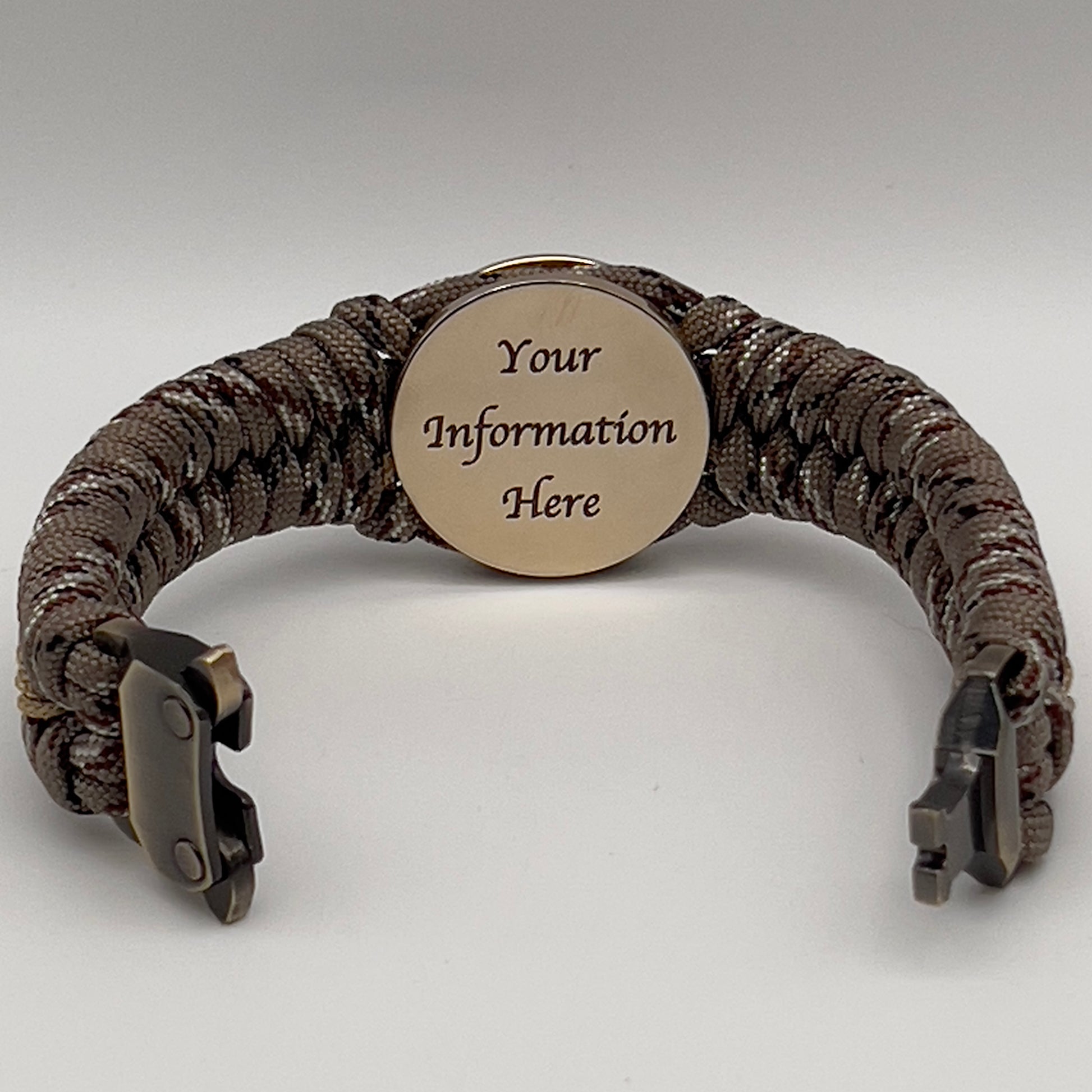 Thick, rigid and comfortable braided United States Marine Corps bracelet featuring a 24K gold plated USMC Eagle Globe and Anchor medallion, a gold Cobra style tactical buckle and woven with Desert Camo 550 paracord.