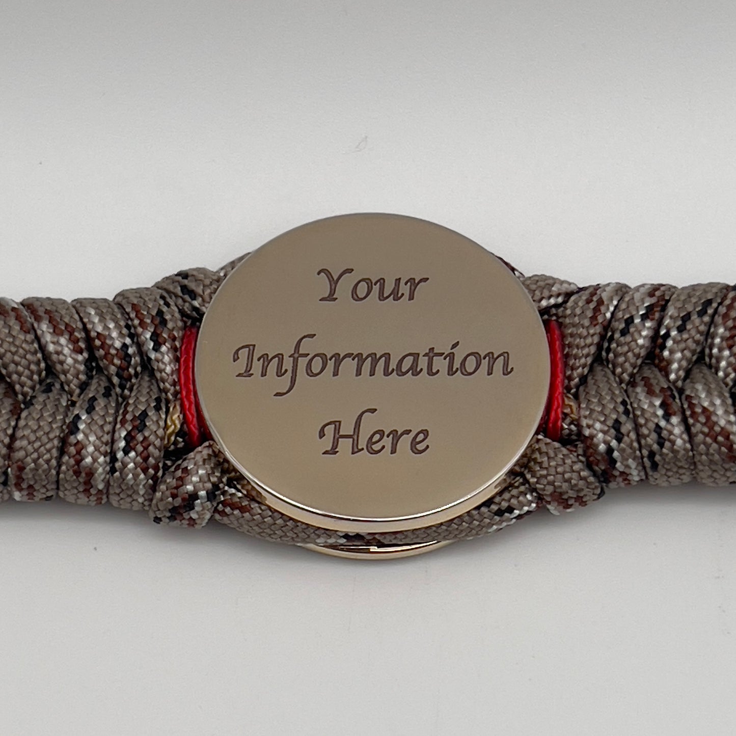 Thick, rigid and comfortable braided United States Marine Corps bracelet featuring a 24K gold plated USMC Eagle Globe and Anchor medallion, a gold Cobra style tactical buckle and woven with Desert Camo 550 paracord and Imperial Red and Gold micro cord.