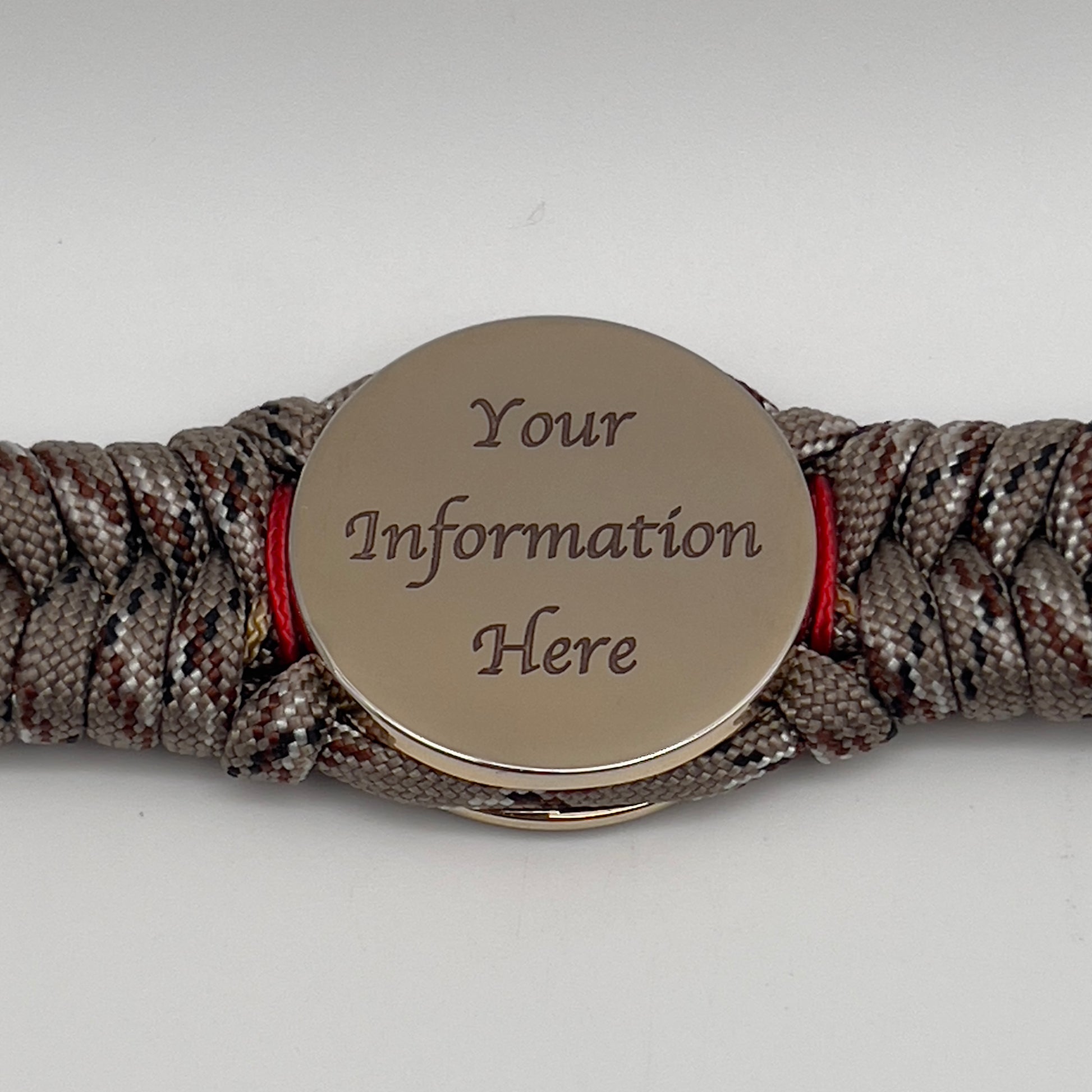 Thick, rigid and comfortable braided United States Marine Corps bracelet featuring a 24K gold plated USMC Eagle Globe and Anchor medallion, a gold Cobra style tactical buckle and woven with Desert Camo 550 paracord and Imperial Red and Gold micro cord.
