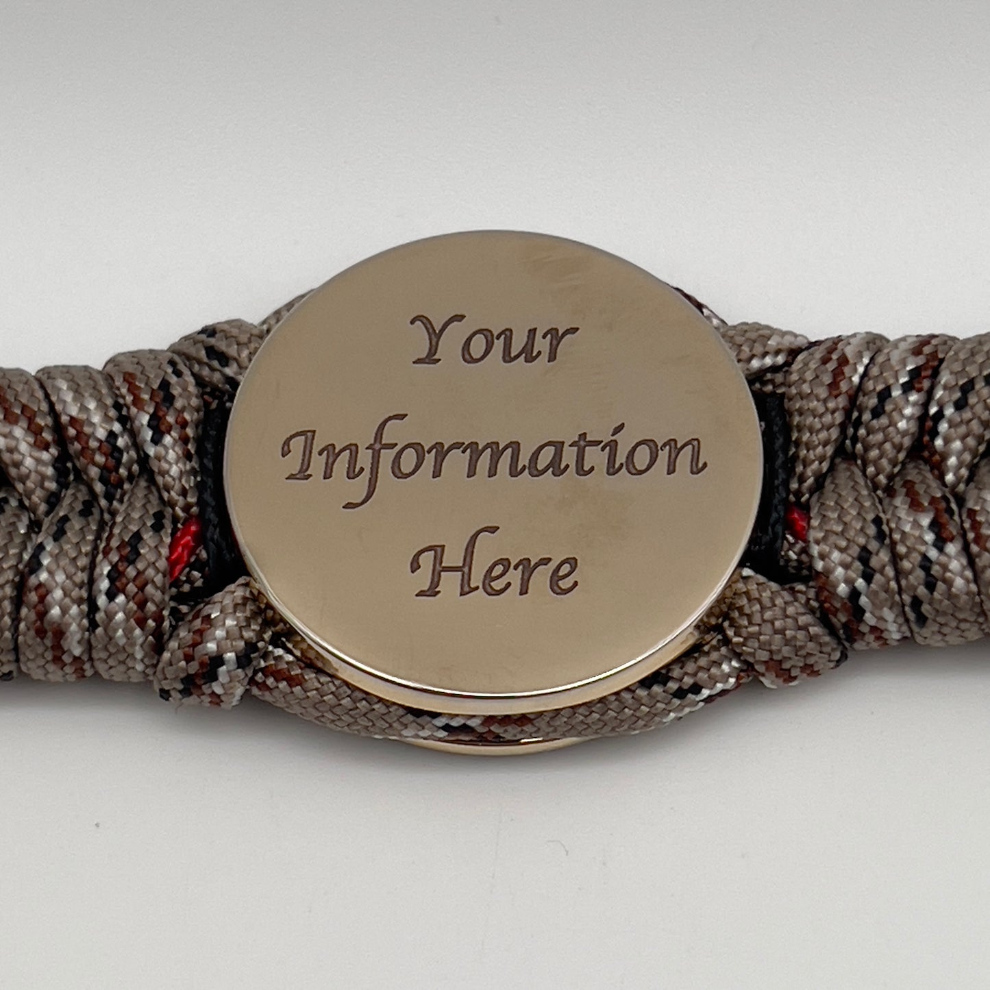 Thick, rigid and comfortable braided United States Marine Corps bracelet featuring a 24K gold plated USMC Eagle Globe and Anchor medallion, a gold Cobra style tactical buckle and woven with Desert Camo 550 paracord and black and Imperial Red micro cord.