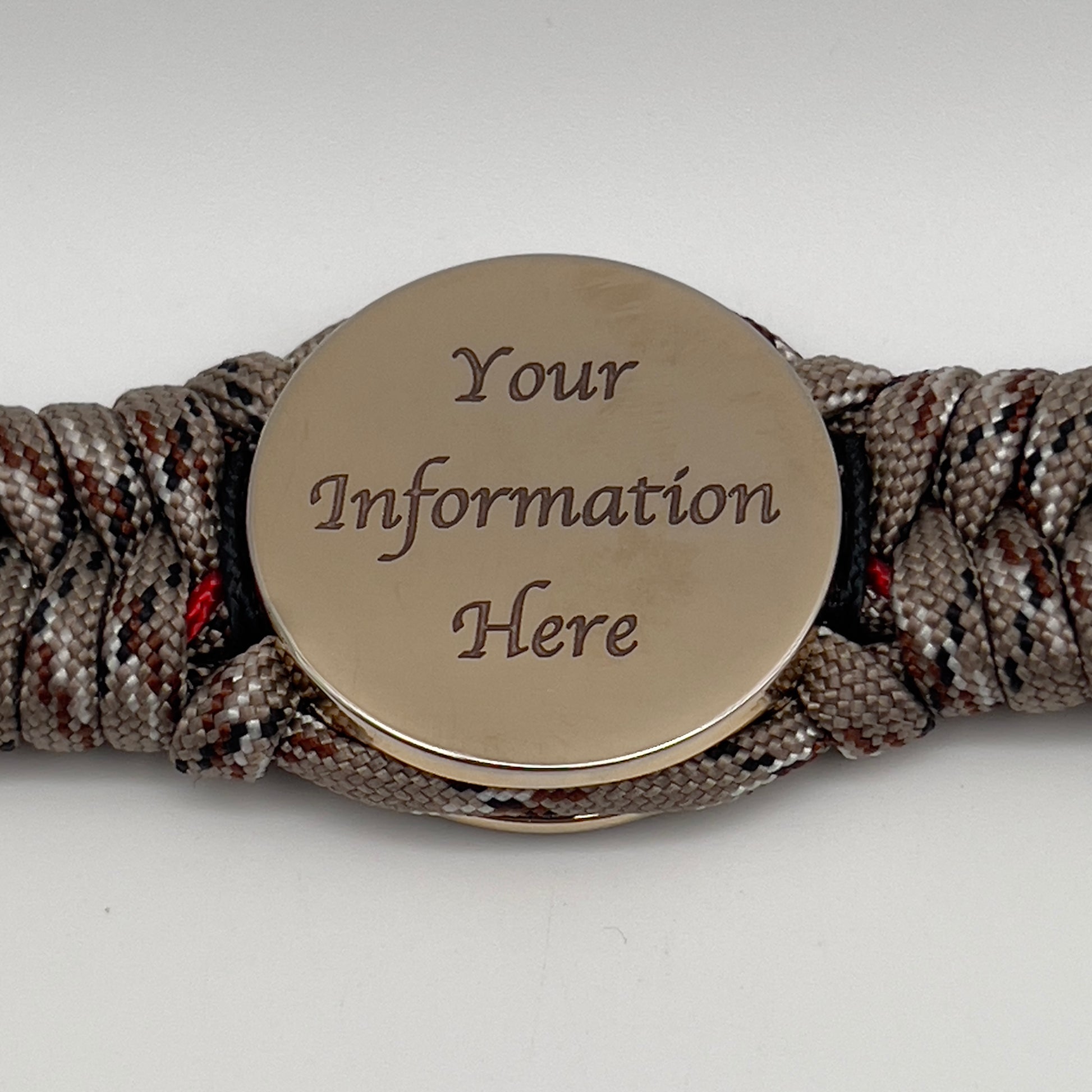 Thick, rigid and comfortable braided United States Marine Corps bracelet featuring a 24K gold plated USMC Eagle Globe and Anchor medallion, a gold Cobra style tactical buckle and woven with Desert Camo 550 paracord and black and Imperial Red micro cord.