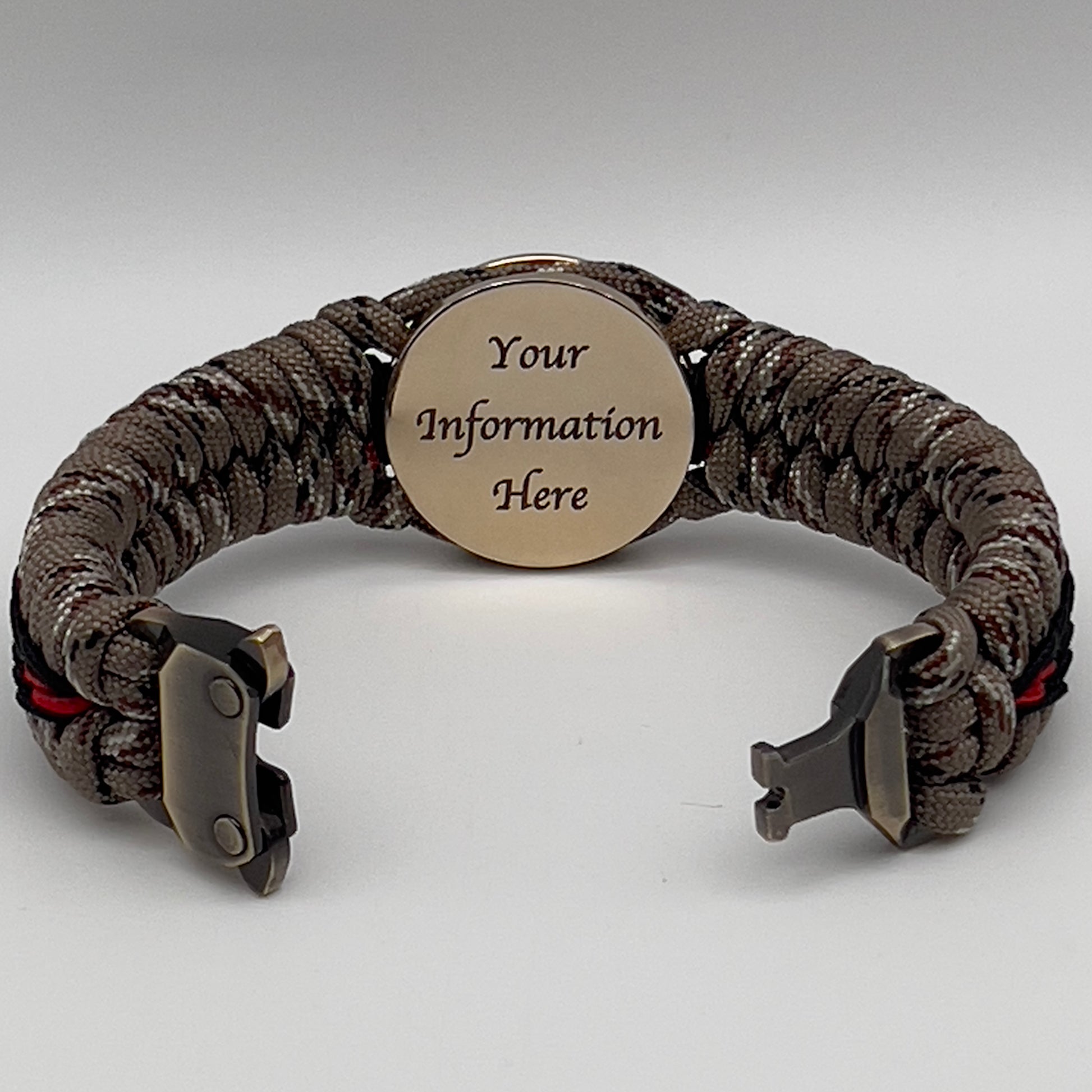Thick, rigid and comfortable braided United States Marine Corps bracelet featuring a 24K gold plated USMC Eagle Globe and Anchor medallion, a gold Cobra style tactical buckle and woven with Desert Camo 550 paracord and black and Imperial Red micro cord.