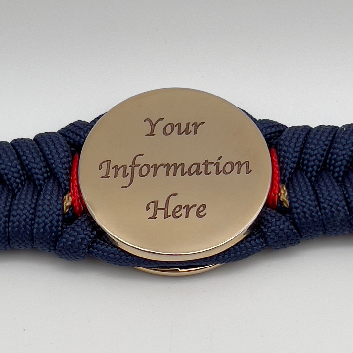 Thick, rigid and comfortable braided United States Marine Corps bracelet featuring a 24K gold plated USMC Eagle Globe and Anchor medallion, a gold Cobra style tactical buckle and woven with Navy Blue 550 paracord and Imperial Red and Gold micro cord.