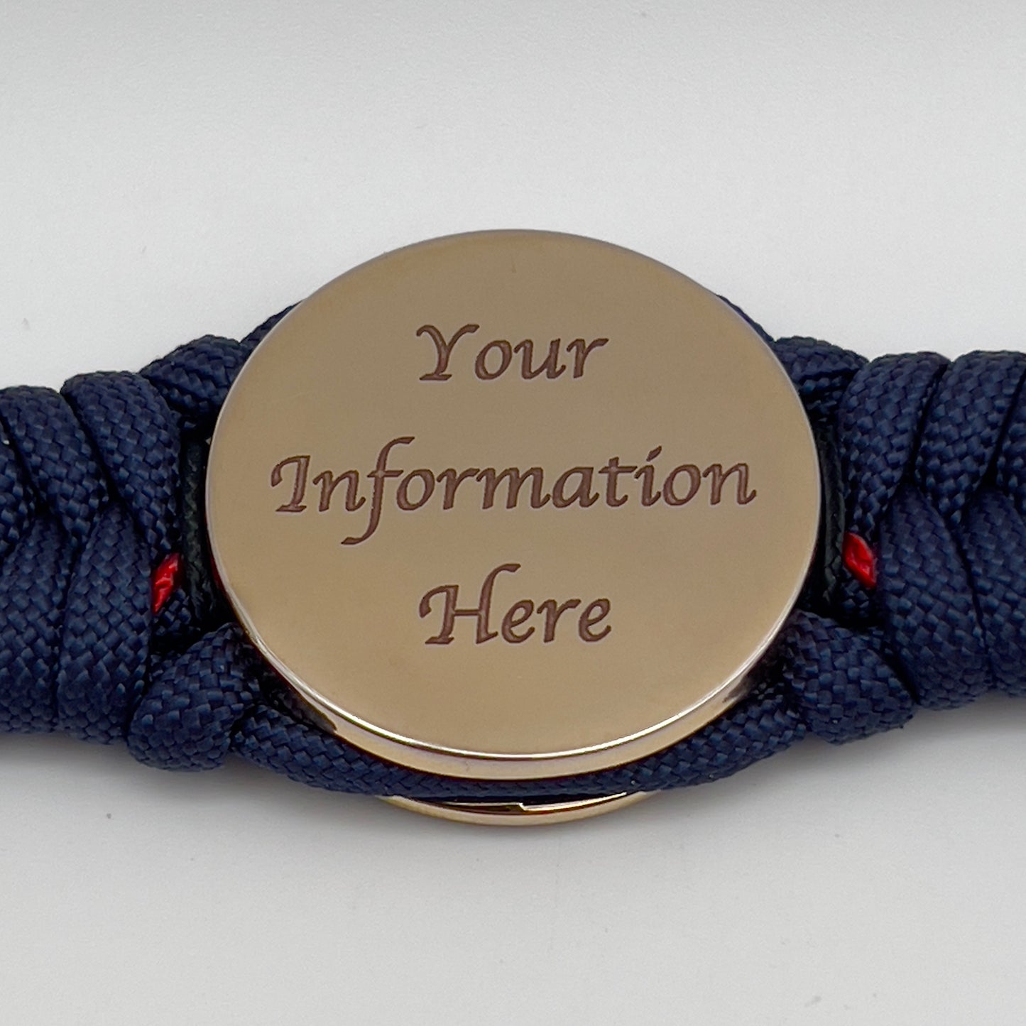 Thick, rigid and comfortable braided United States Marine Corps bracelet featuring a 24K gold plated USMC Eagle Globe and Anchor medallion, a gold Cobra style tactical buckle and woven with Navy Blue 550 paracord and Imperial Red and Black micro cord.