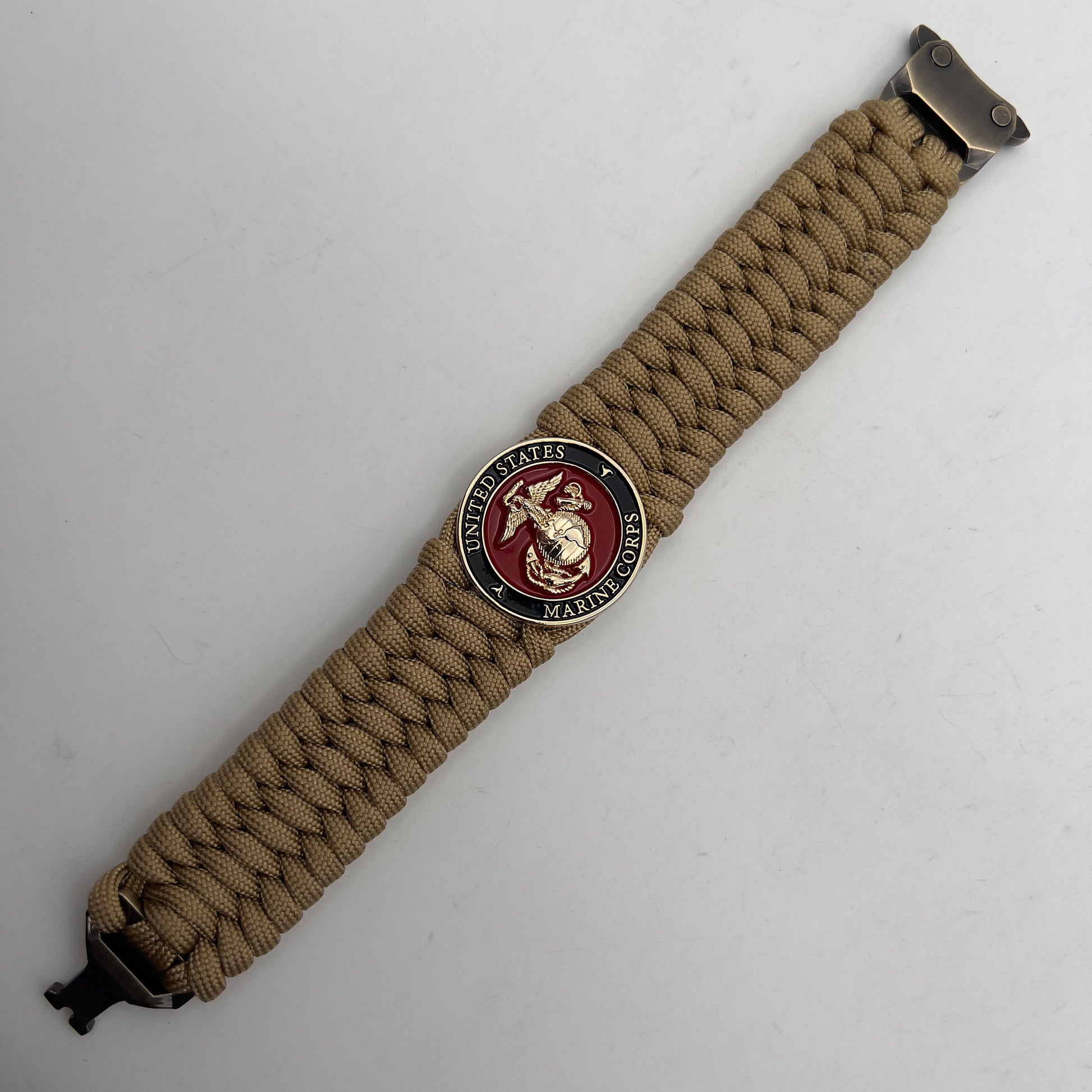 Thick, wide, rigid and comfortable braided United States Marine Corps bracelet featuring a 24K gold plated USMC Eagle Globe and Anchor medallion, a gold Cobra style tactical buckle and woven with gold 550 paracord.