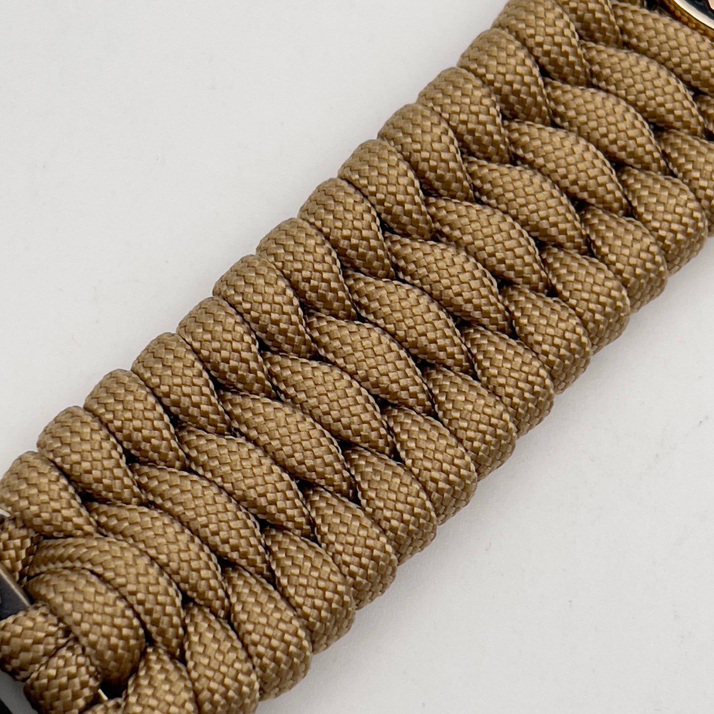 Thick, wide, rigid and comfortable braided United States Marine Corps bracelet featuring a 24K gold plated USMC Eagle Globe and Anchor medallion, a gold Cobra style tactical buckle and woven with gold 550 paracord.