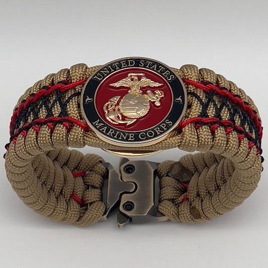 Thick, wide, rigid and comfortable braided United States Marine Corps bracelet featuring a 24K gold plated USMC Eagle Globe and Anchor medallion, a gold Cobra style tactical buckle and woven with gold 550 paracord and Imperial Red micro and black nano cord.