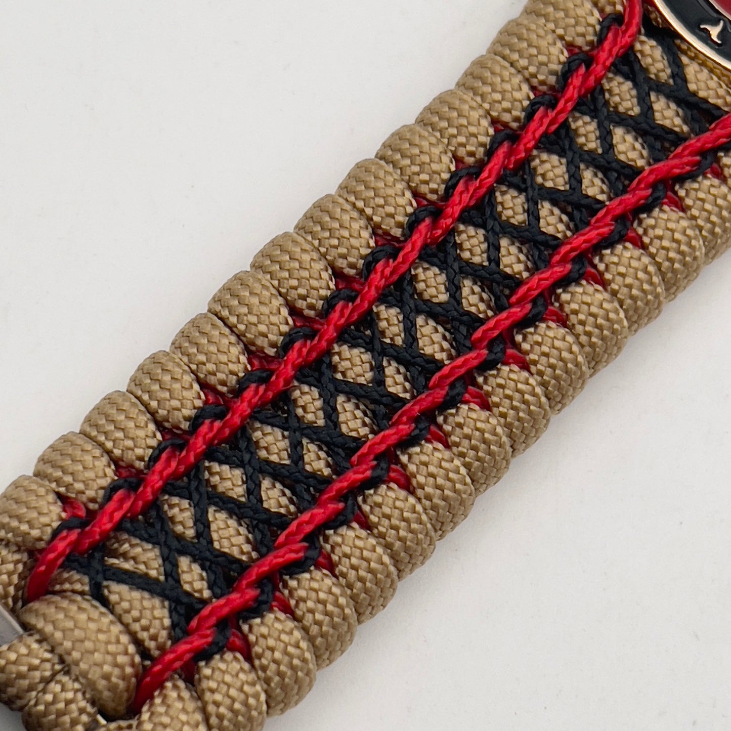 Thick, wide, rigid and comfortable braided United States Marine Corps bracelet featuring a 24K gold plated USMC Eagle Globe and Anchor medallion, a gold Cobra style tactical buckle and woven with gold 550 paracord and Imperial Red micro and black nano cord.