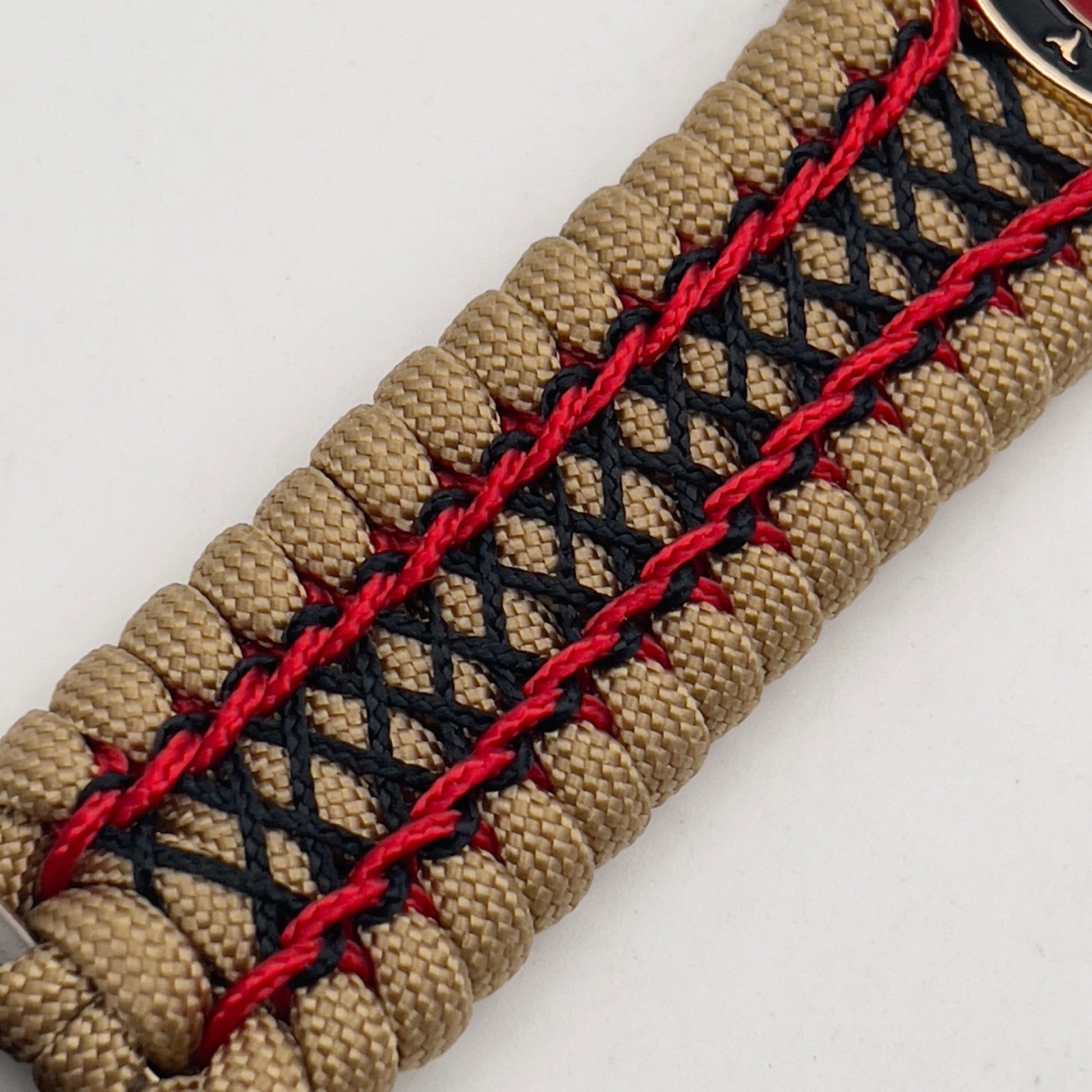 Thick, wide, rigid and comfortable braided United States Marine Corps bracelet featuring a 24K gold plated USMC Eagle Globe and Anchor medallion, a gold Cobra style tactical buckle and woven with gold 550 paracord and Imperial Red micro and black nano cord.