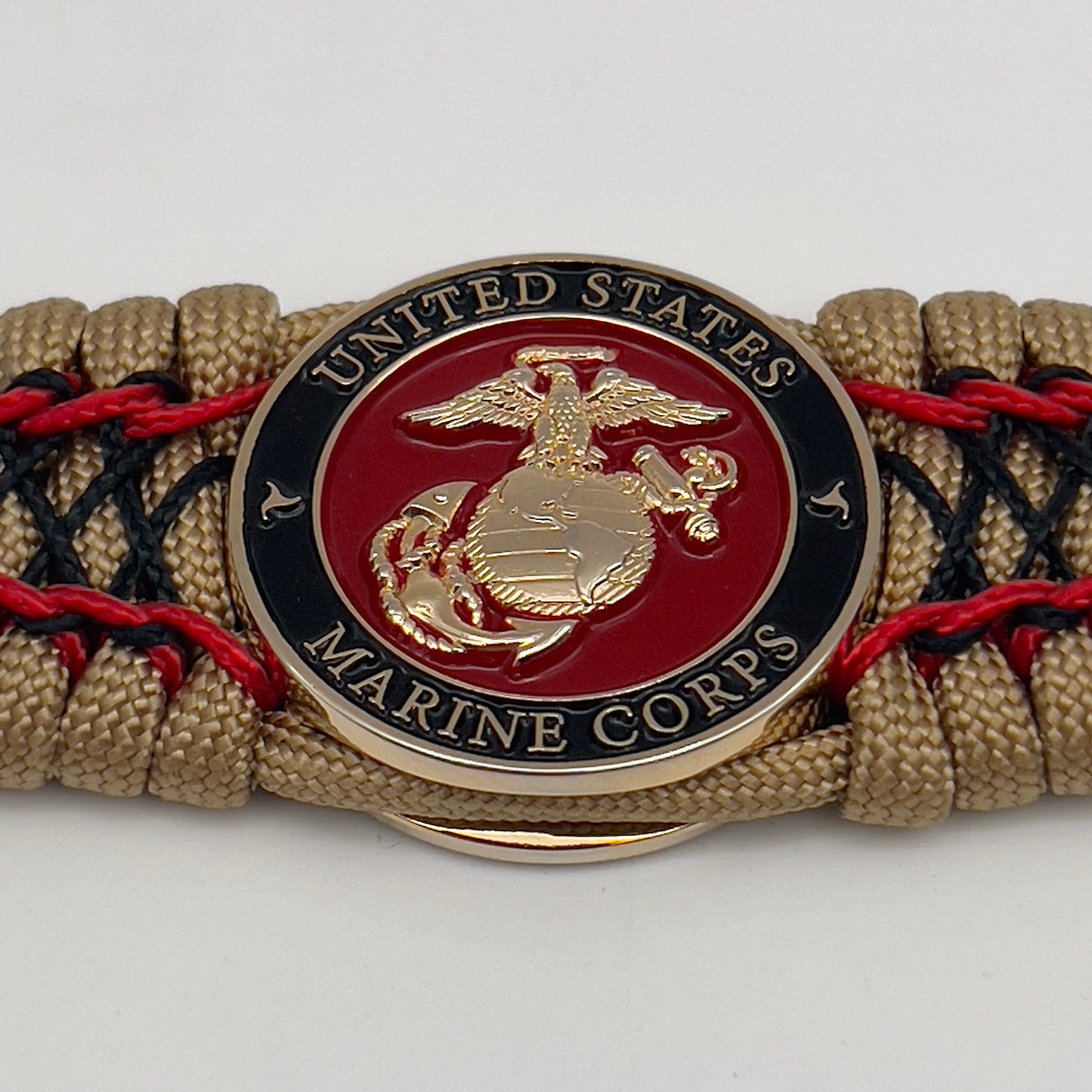 Thick, wide, rigid and comfortable braided United States Marine Corps bracelet featuring a 24K gold plated USMC Eagle Globe and Anchor medallion, a gold Cobra style tactical buckle and woven with gold 550 paracord and Imperial Red micro and black nano cord.