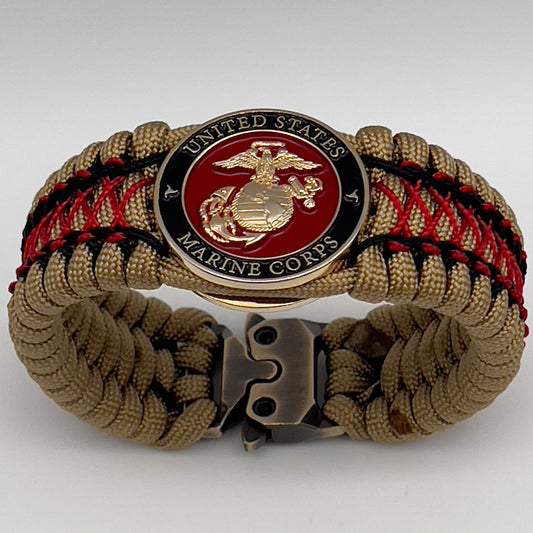 Thick, wide, rigid and comfortable braided United States Marine Corps bracelet featuring a 24K gold plated USMC Eagle Globe and Anchor medallion, a gold Cobra style tactical buckle and woven with gold 550 paracord and Imperial Red micro and black nano cord.