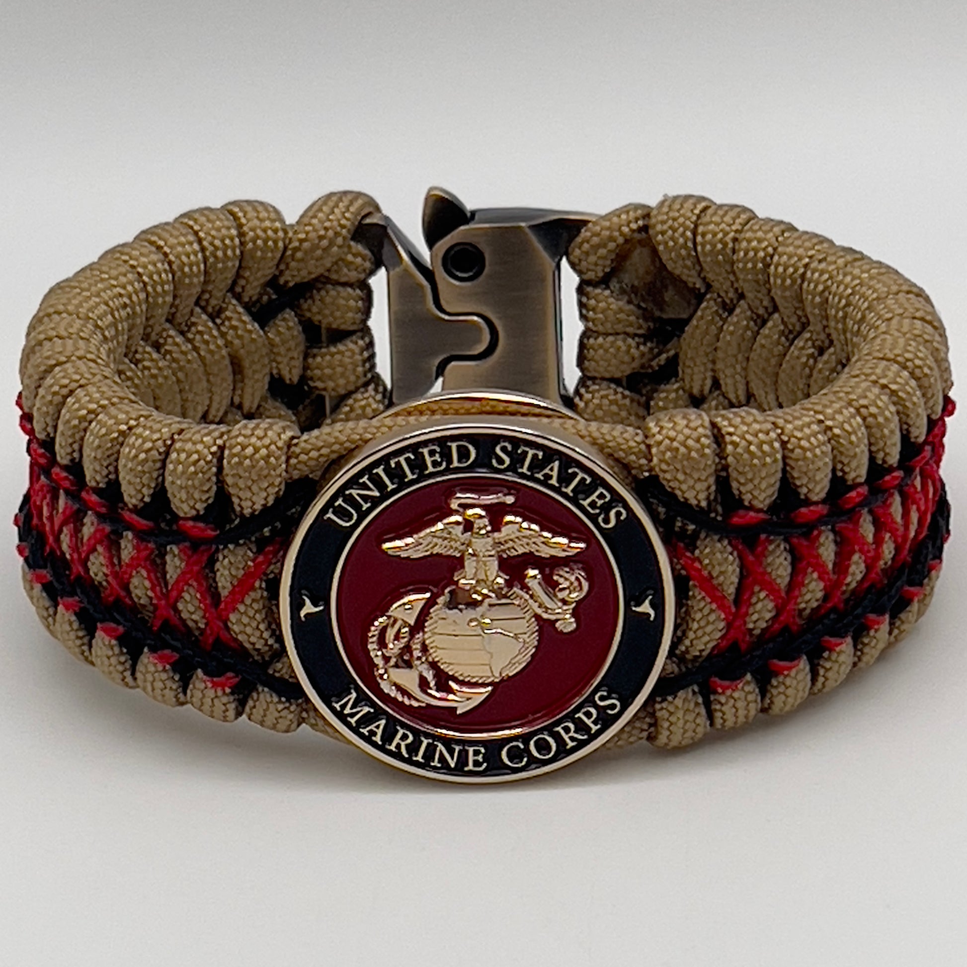Thick, wide, rigid and comfortable braided United States Marine Corps bracelet featuring a 24K gold plated USMC Eagle Globe and Anchor medallion, a gold Cobra style tactical buckle and woven with gold 550 paracord and Imperial Red micro and black nano cord.