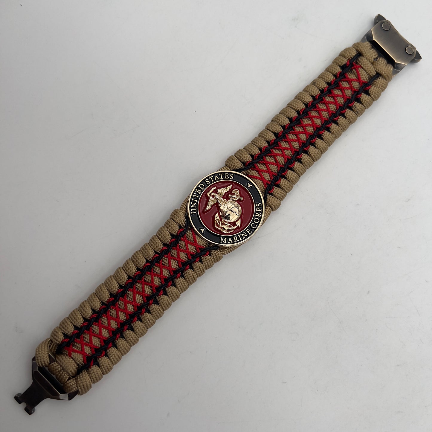 Thick, wide, rigid and comfortable braided United States Marine Corps bracelet featuring a 24K gold plated USMC Eagle Globe and Anchor medallion, a gold Cobra style tactical buckle and woven with gold 550 paracord and Imperial Red micro and black nano cord.