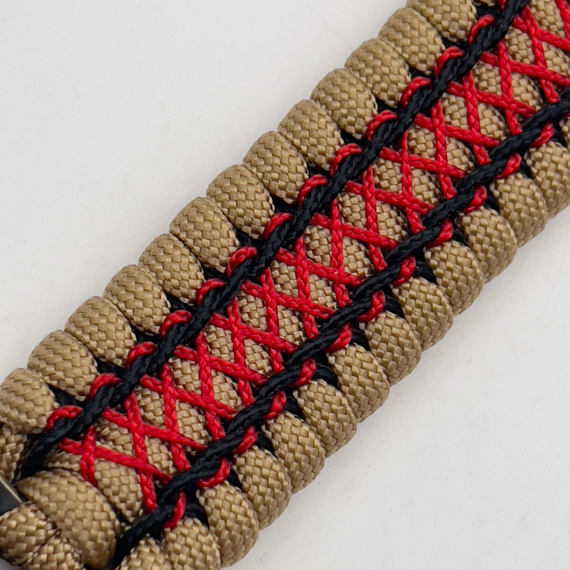 Thick, wide, rigid and comfortable braided United States Marine Corps bracelet featuring a 24K gold plated USMC Eagle Globe and Anchor medallion, a gold Cobra style tactical buckle and woven with gold 550 paracord and Imperial Red micro and black nano cord.